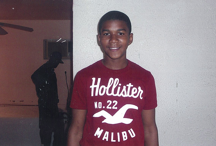 In this undated family photo, Trayvon Martin poses for a family photo. The family of the black teenager fatally shot by a white neighborhood watch volunteer arrived at Sanford City Hall Friday evening March 16, 2012 to listen to recordings of 911 calls police previously refused to release. Police agreed to release the recordings earlier that afternoon. Officials are allowing the family of 17-year-old Trayvon Martin to hear the recordings before making them public. Martin's parents previously sued to have the recordings released. A hearing for the case was scheduled for Monday. Martin was fatally shot last month as he returned to a Sanford home during a visit from Miami. His parents, Tracy Martin and Sybrina Fulton, accused Sanford police of botching the investigation and criticized them for not arresting 28-year-old George Zimmerman, who says he shot Trayvon Martin in self-defense. Martin was not armed. They say the police department hasn't arrested Zimmerman because he is white and their son was black.