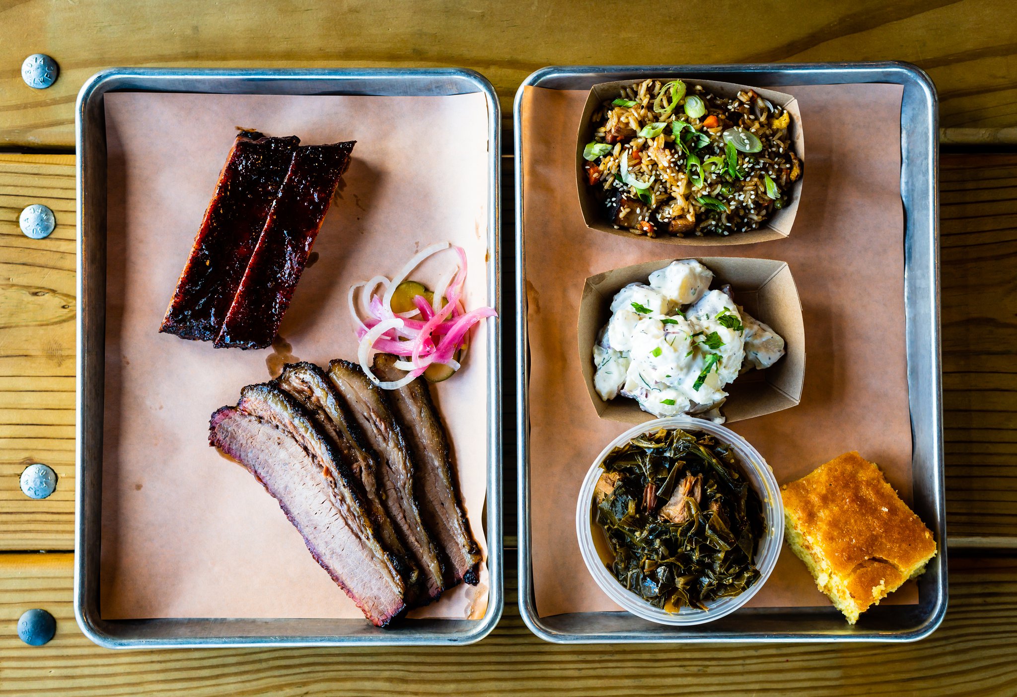 A two-meat plate of St. Louis-style pork ribs and beef brisket with three sides and cornbread.. The two-meat plate typically includes two sides. CONTRIBUTED BY HENRI HOLLIS