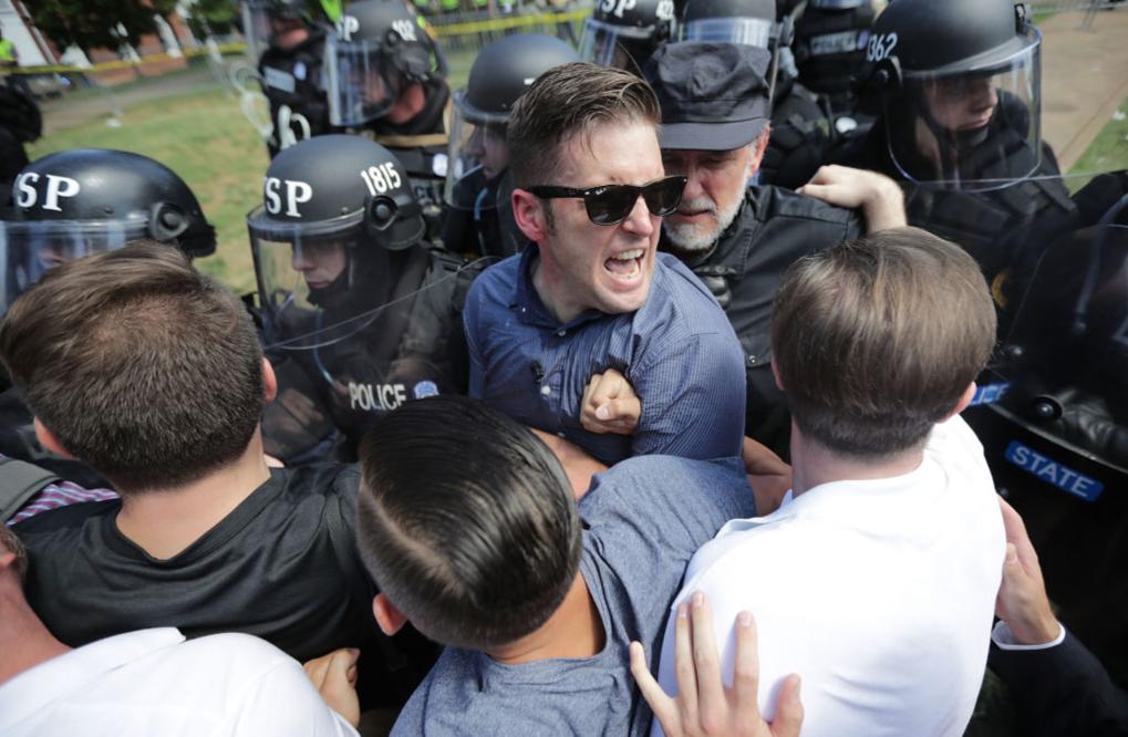 CHARLOTTESVILLE, VA - AUGUST 12: White nationalist Richard Spencer (C) and his supporters clash with Virginia State Police in Emancipation Park after the "Unite the Right" rally was declared an unlawful gathering August 12, 2017 in Charlottesville, Virginia. Hundreds of white nationalists, neo-Nazis and members of the "alt-right" clashed with anti-fascist protesters and police as they attempted to hold a rally in Emancipation Park, where a statue of Confederate General Robert E. Lee is slated to be removed.
