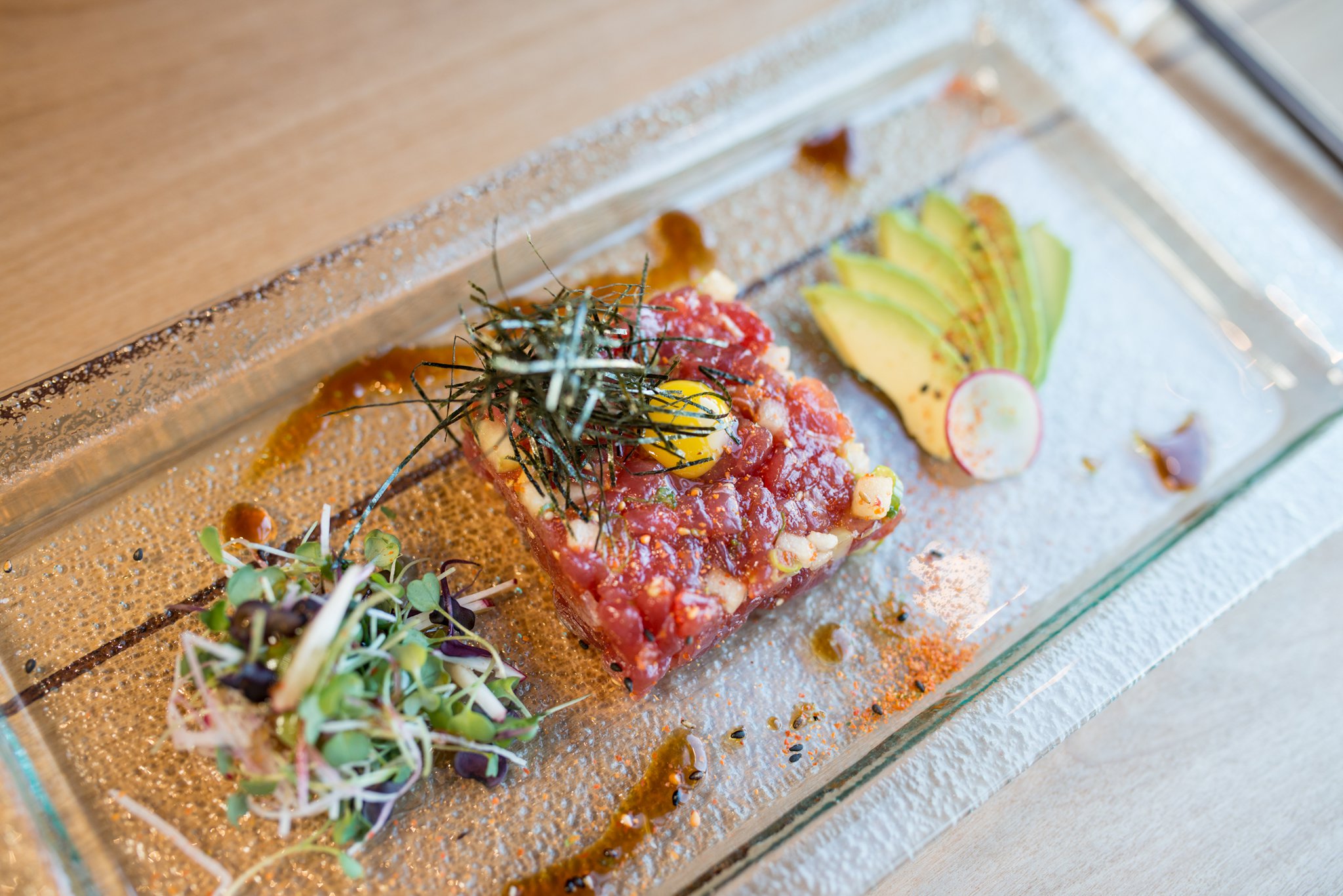 Hopstix Tuna Tartare starter with asian pear, avocado, pine nuts, and quail egg. Photo credit- Mia Yakel.
