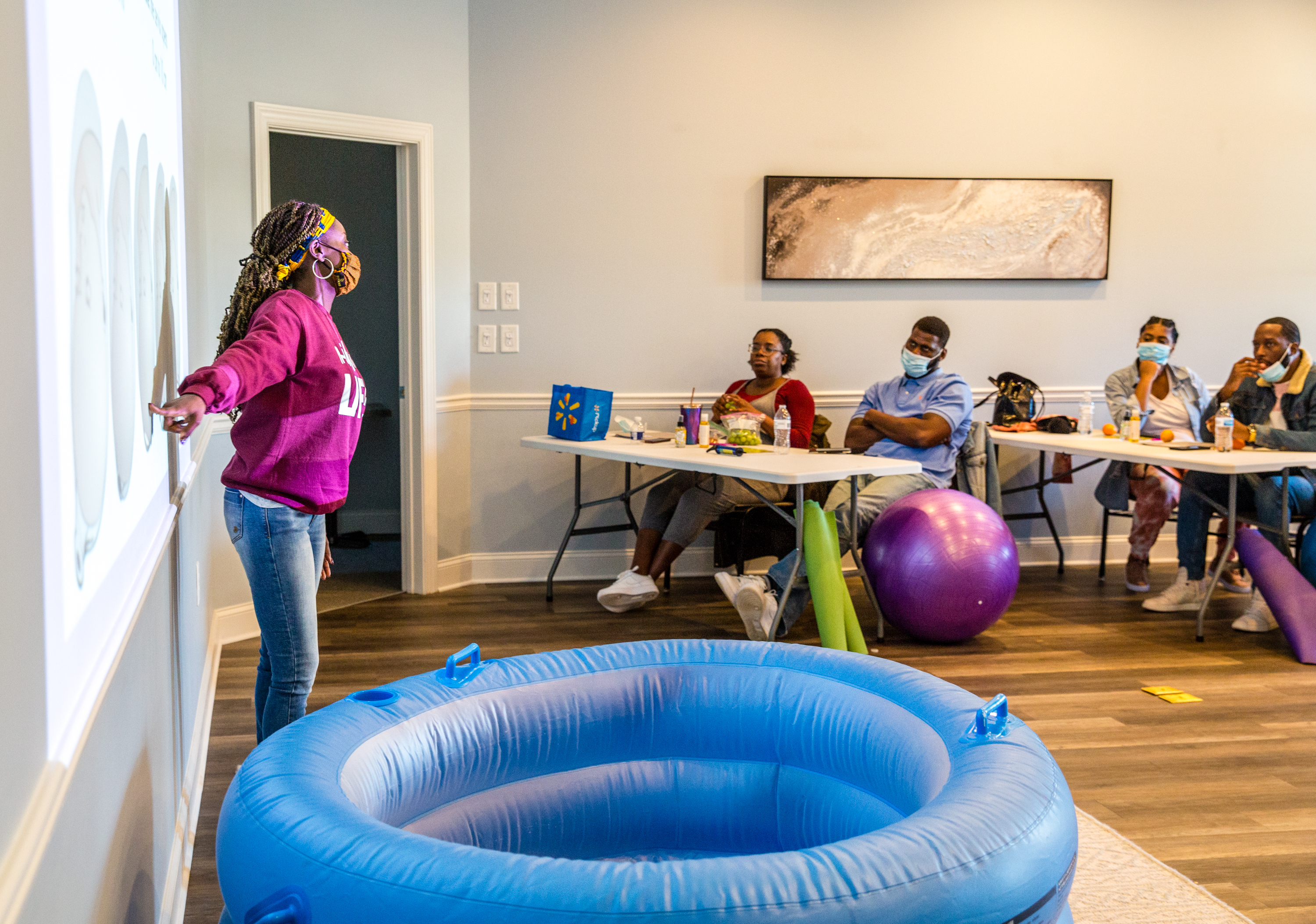 Certified nurse-midwife Christine Taylor, owner of the practice Birth by Grace, holds a birthing class for a few couples in Peachtree City on Saturday, Jan. 23, 2021. The families are planning home births under the guidance of Taylor and doula Dawn Hutcherson. (Jenni Girtman for The Atlanta Journal-Constitution)
