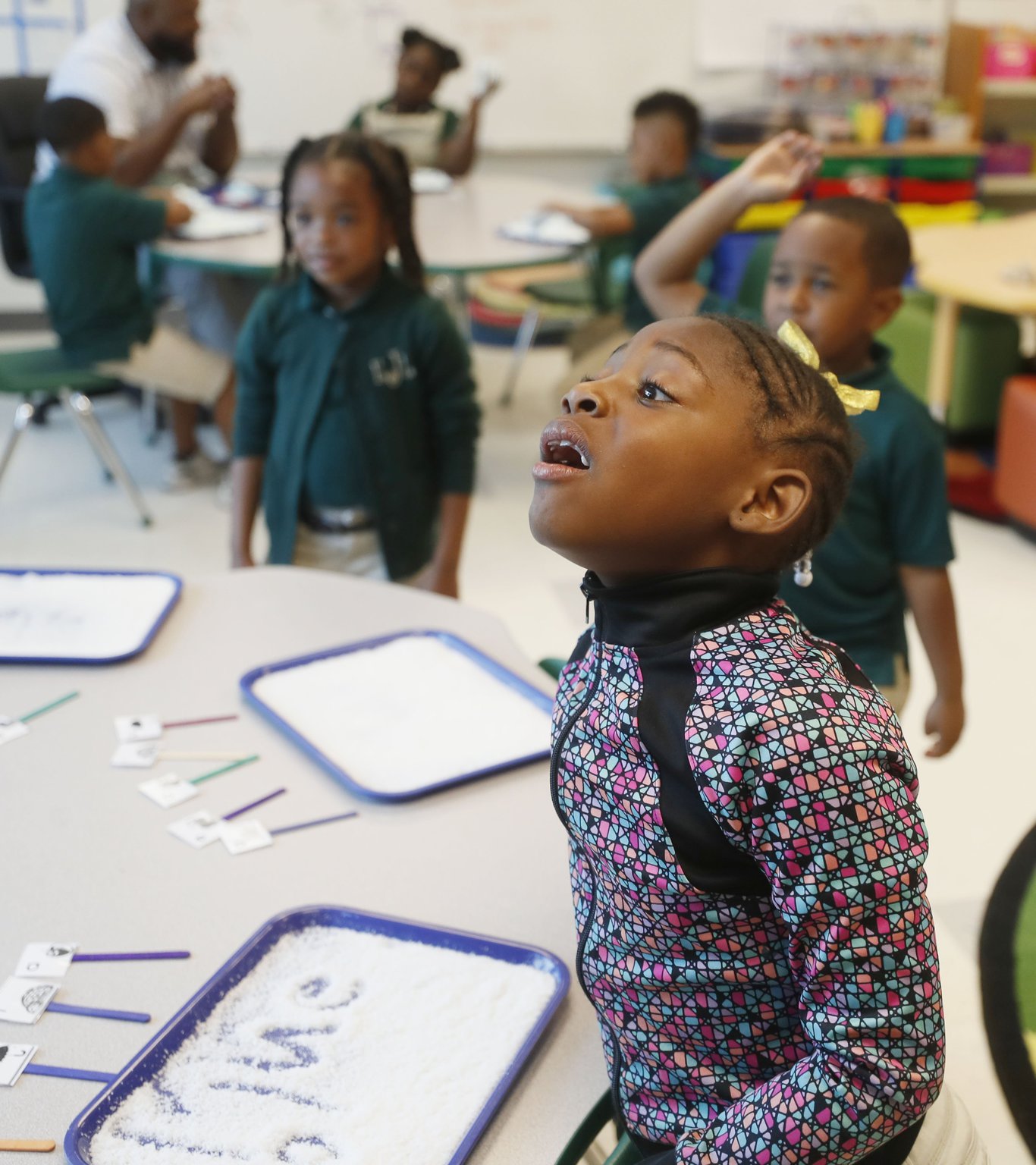 Jada Gray, 6, spells out a word during a sound stretching activity in the literacy center at Charles R. Drew Charter School in Atlanta. The activity helps students segment sounds and words. Nonsense words are used to ensure students can apply the phonics rules they’ve learned.