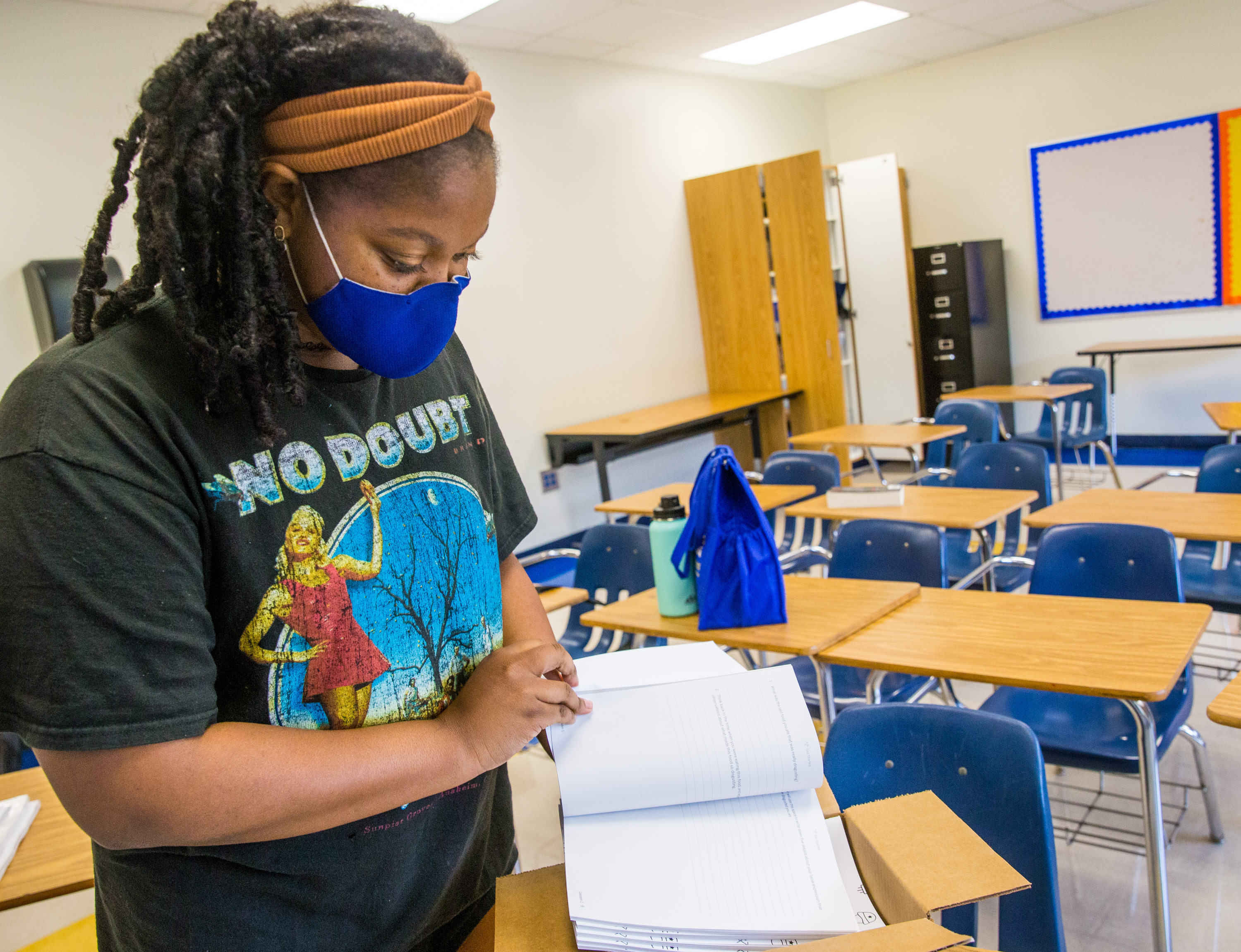 John Lewis Invictus Academy begins the 2021-2022 school year on Thursday, Aug 5. Kendle Ramsey organizes her 7th grade english classroom at the Atlanta Public School middle school Friday, July 30, 2021. Ramsey, a Mississippi native whose mother is also a 7th grade english teacher, began her teaching career during the pandemic and has worked in person during summer school. She is not certain how this school year will proceed but is excited to get started. (Jenni Girtman for The Atlanta Journal-Constitution)