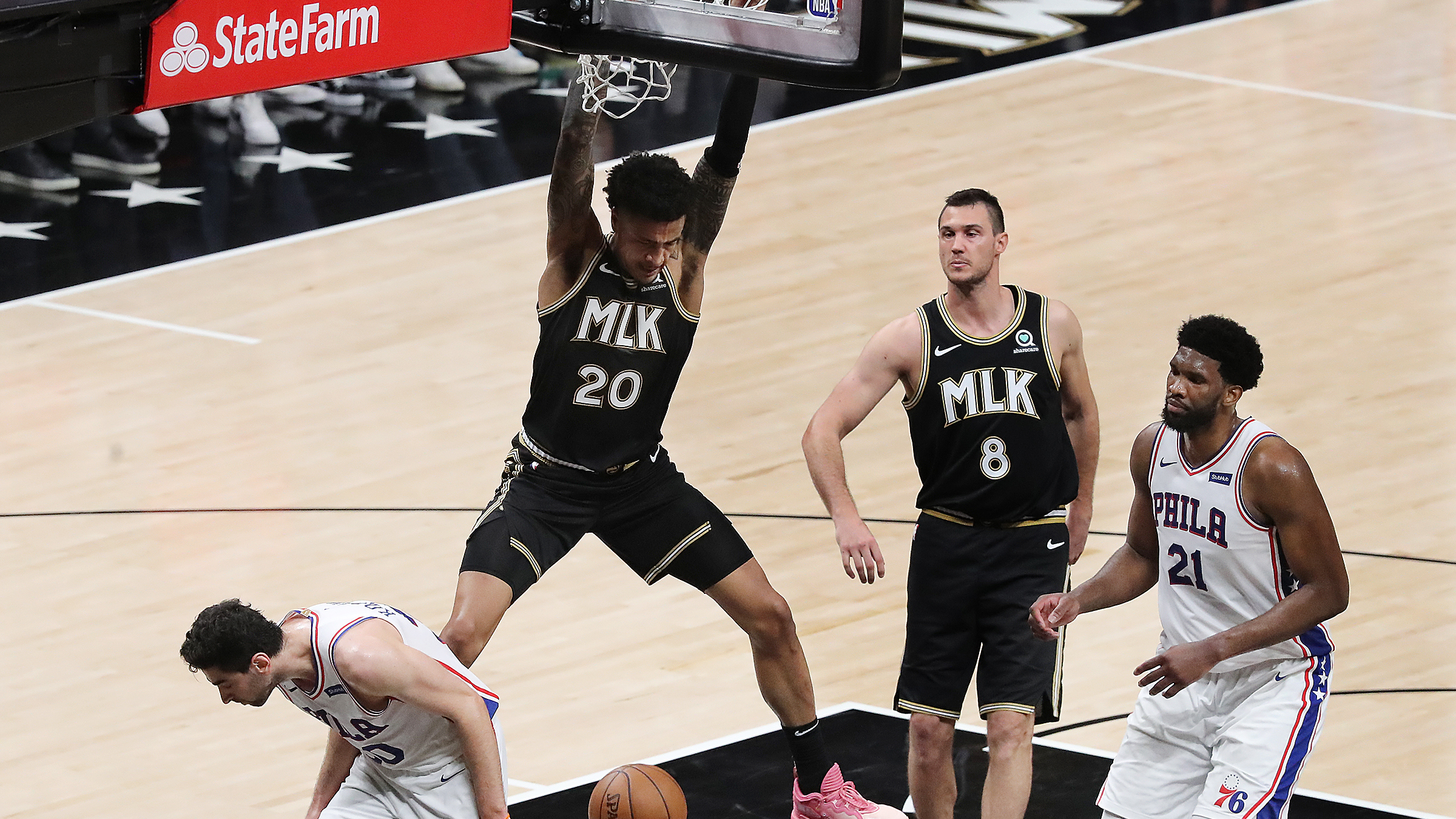 John Collins slams home one of several key baskets for the Hawks during their second-half comeback in a Game 4 victory over the 76ers at State Farm Arena.