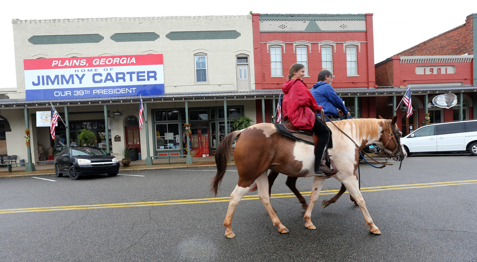 September 25, 2015 Plains: Dr. Frank Pierce, the veterinarian in Plains, and his daughter ride horses down Main Street in Plains on Friday afternoon September 25, 2015. Ben Gray / bgray@ajc.com