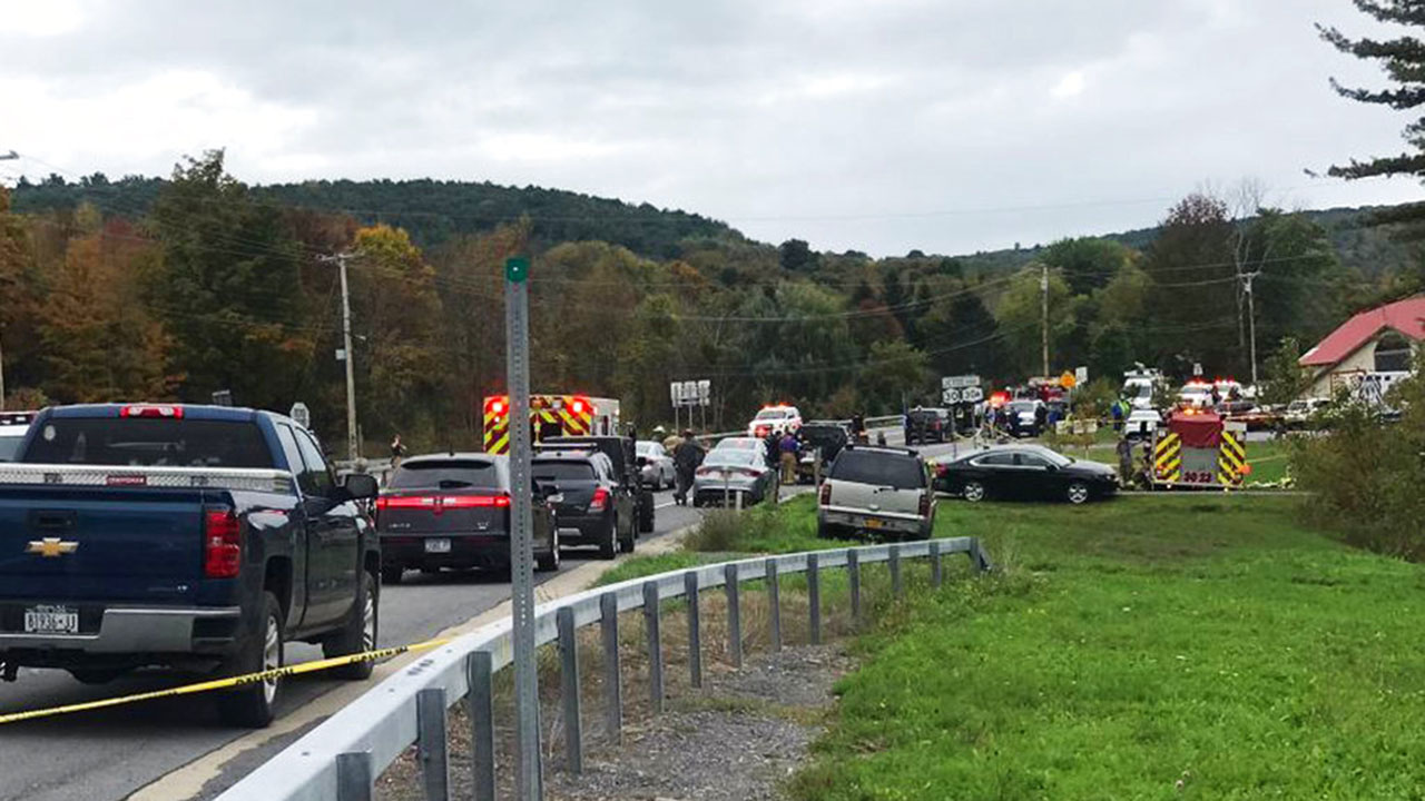 In this Saturday, Oct. 6, 2018 photo, emergency personnel respond to the scene of a deadly crash in Schoharie, N.Y. (WTEN via AP)