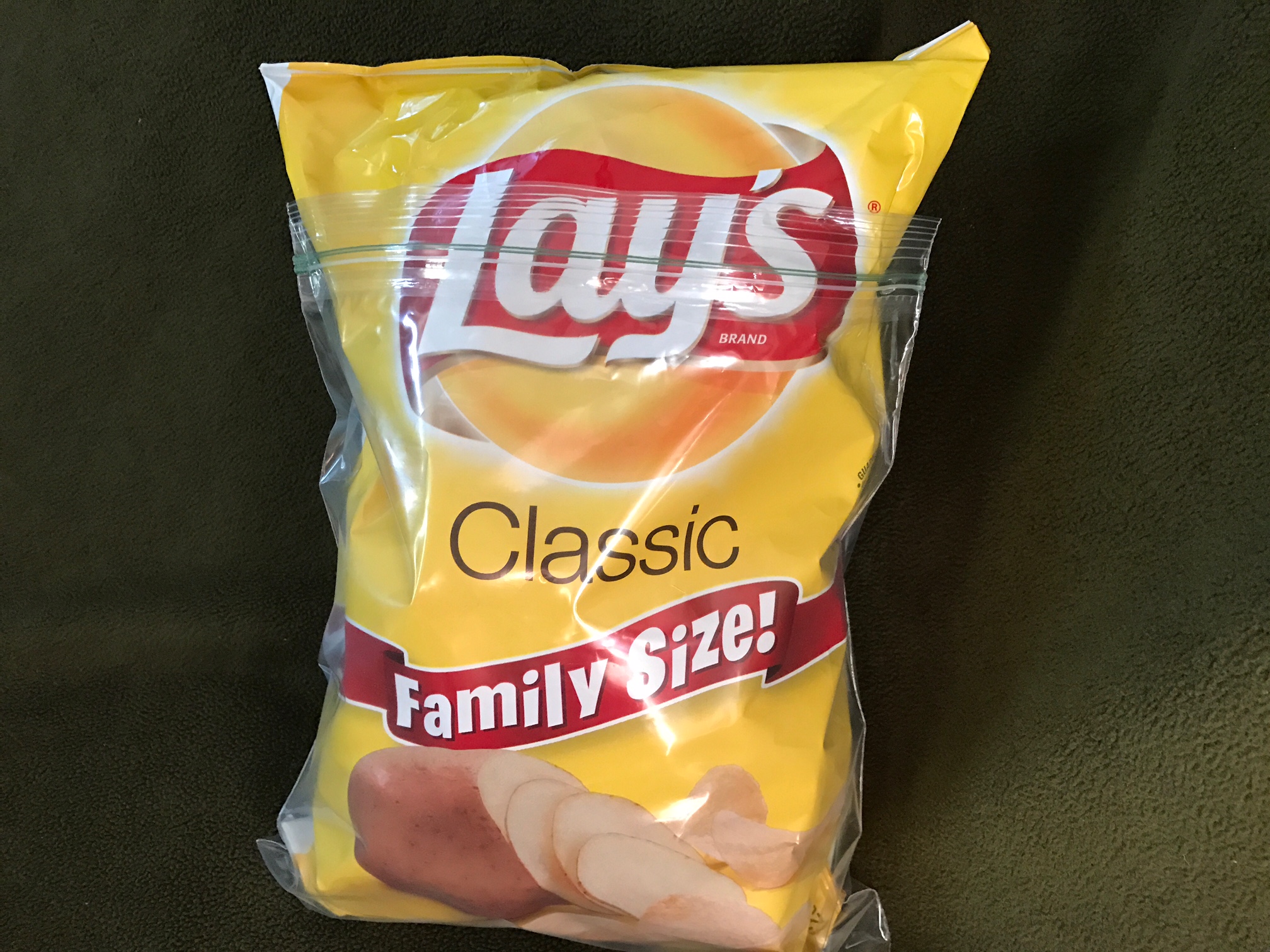 Store-bought family size snacks such as potato chips do not fit into a gallon bag unless the bag is opened to remove air. / Photo by Ligaya Figueras