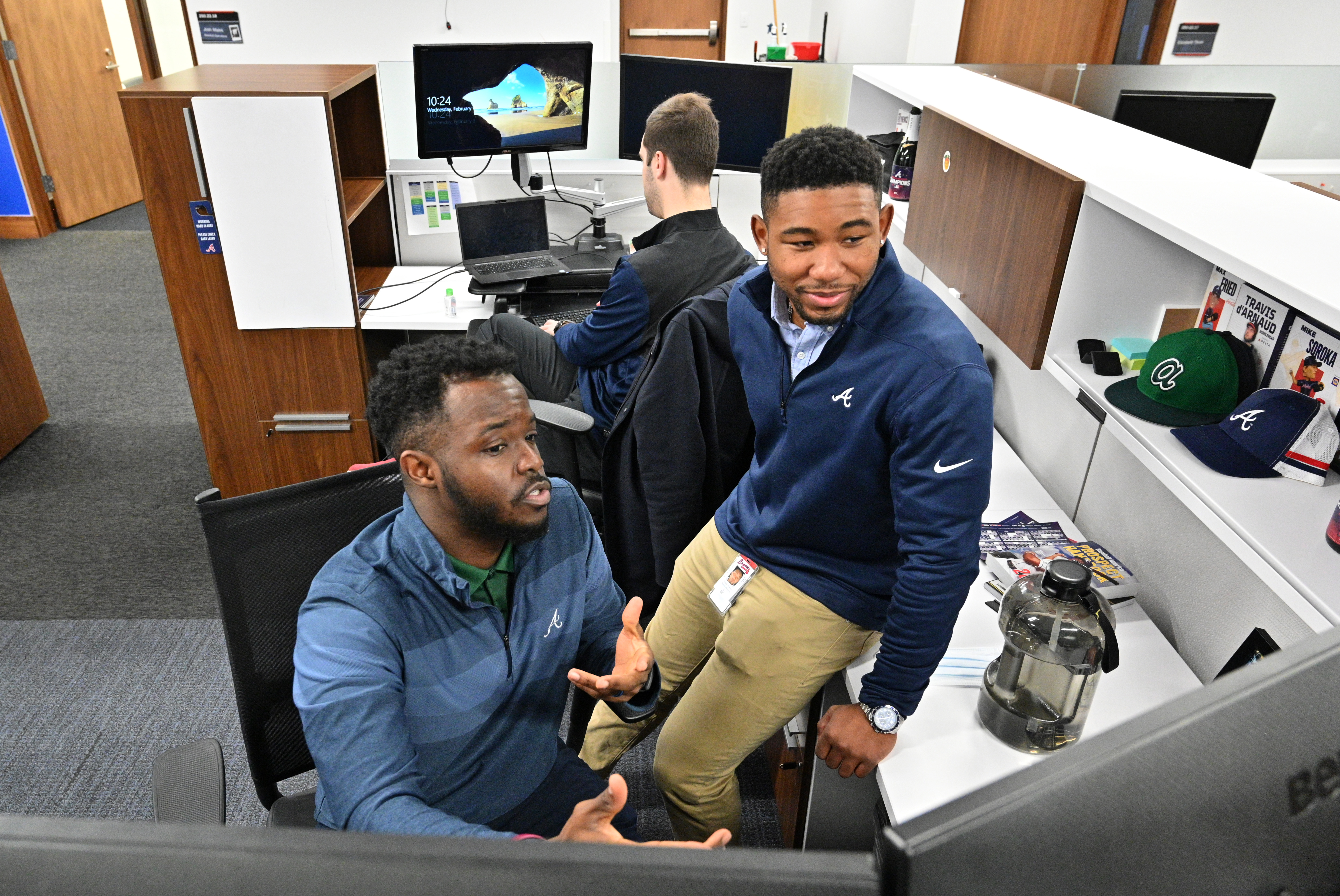 Jeremy Dorsey (left) talks with Terrence Pinkston in the Braves' offices at Truist Park on Wednesday. Both joined the organization as members of the "Bill Lucas Fellowship" program. (Hyosub Shin / Hyosub.Shin@ajc.com)