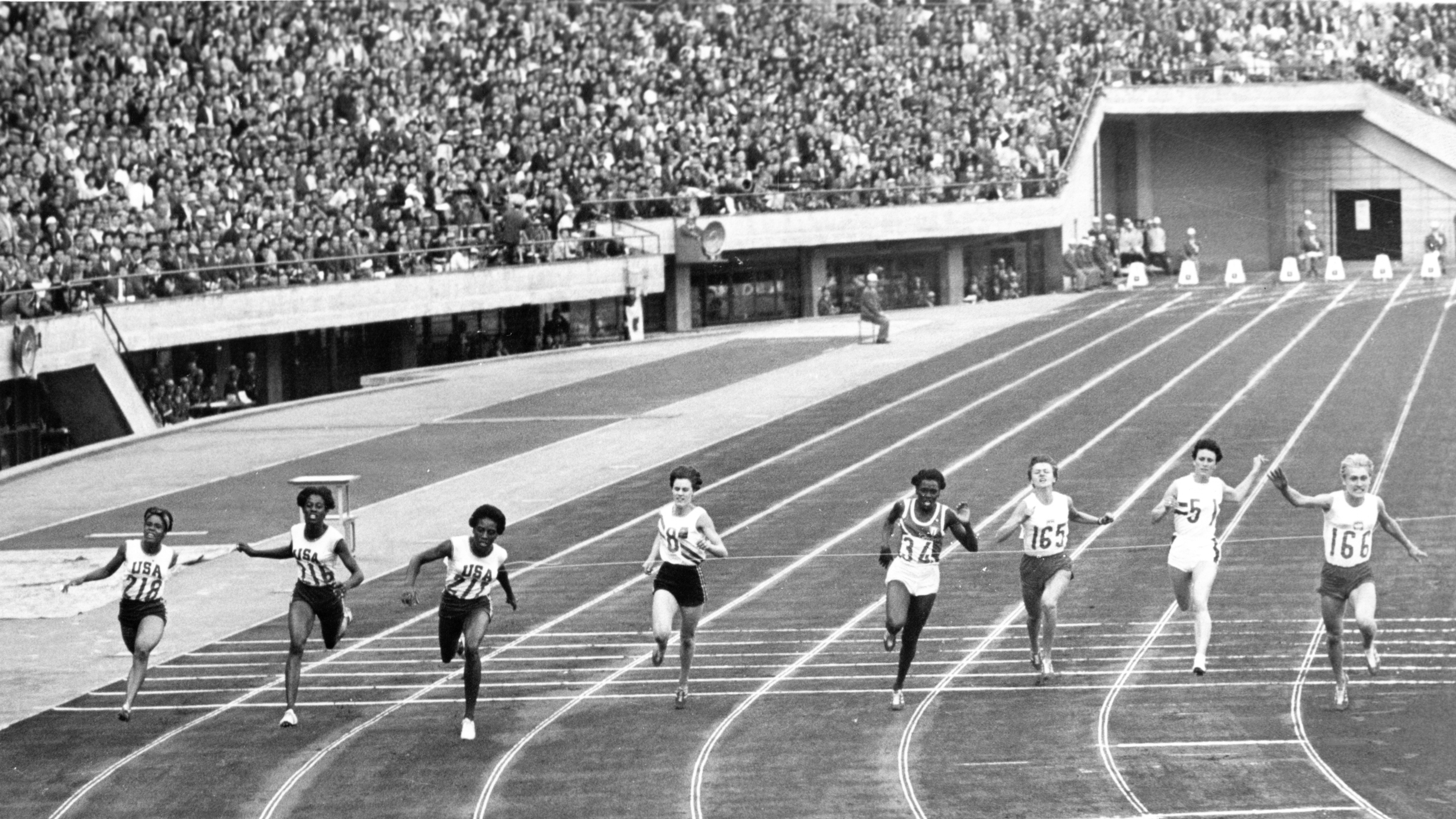 Finalists of the women's 100-meter during dash final of the Summer Olympic event Oct. 16, 1964 in Tokyo. American Wyomia Tyus cuts the ribbon in 11.4 sec. Second was fellow American Edith McGuire (second from left) and third Ewa Klobukowsk, of Poland (top right). Others are Marilyn White, of U.S. (extreme left), Marilyn Black, of Australia (8), and Miguelina Cobian, of Cuba (34). (AP)