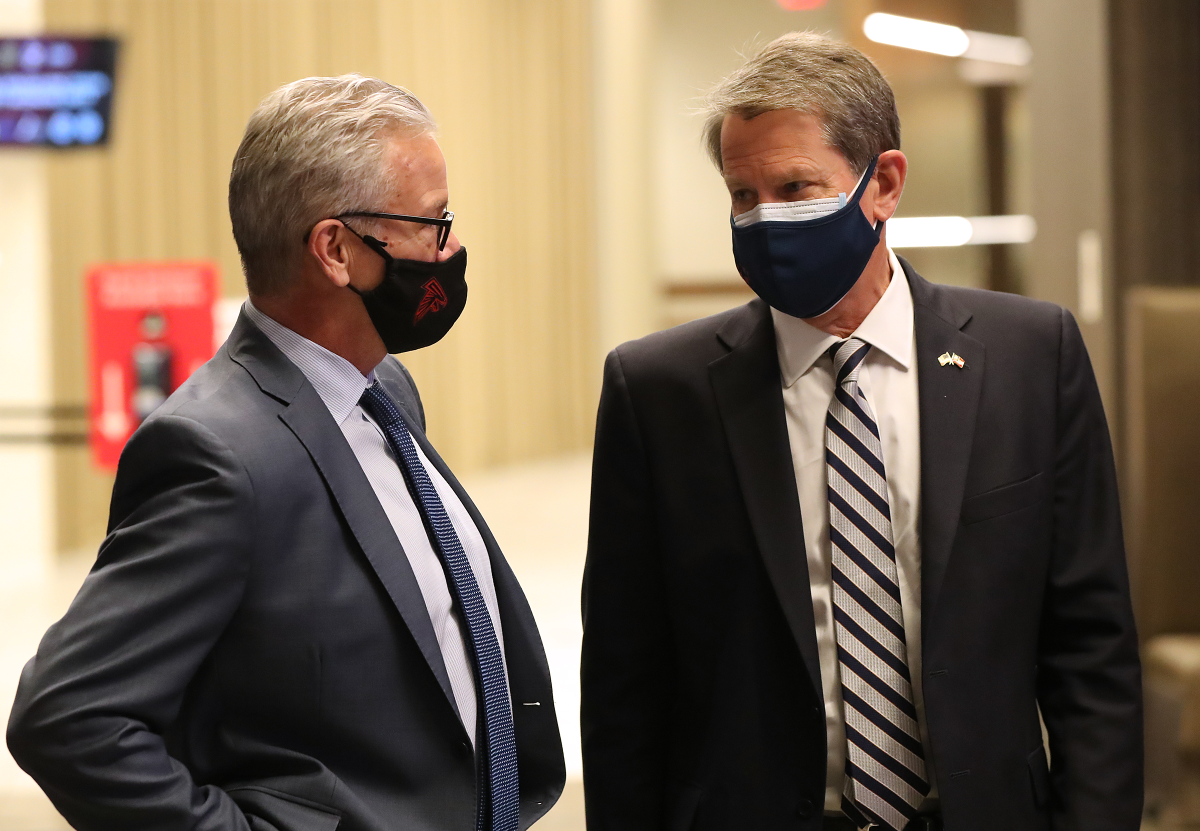 Steve Cannon (left), CEO of AMB Sports and Entertainment, confers with Gov. Brian Kemp as operations get underway for Mercedes-Benz Stadium to become the largest community vaccination center in the Southeast on March 23, 2021. (Curtis Compton / Curtis.Compton@ajc.com)