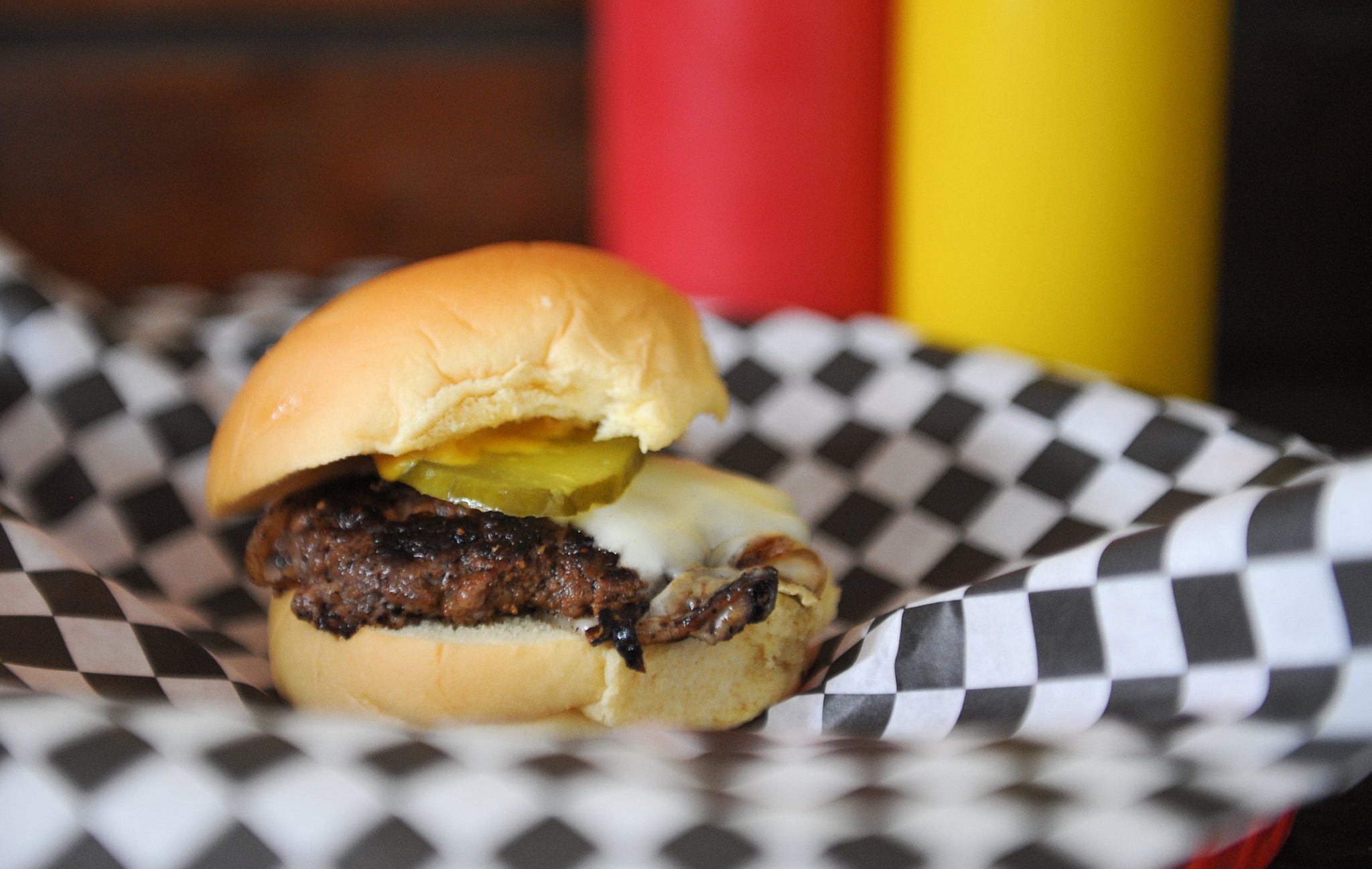 Single cheese -- a 2 oz patty, ground fresh in house, served with American cheese, grilled onions, mustard and pickles -- at Little’s Food Store in Cabbagetown. (BECKY STEIN PHOTOGRAPHY.COM)