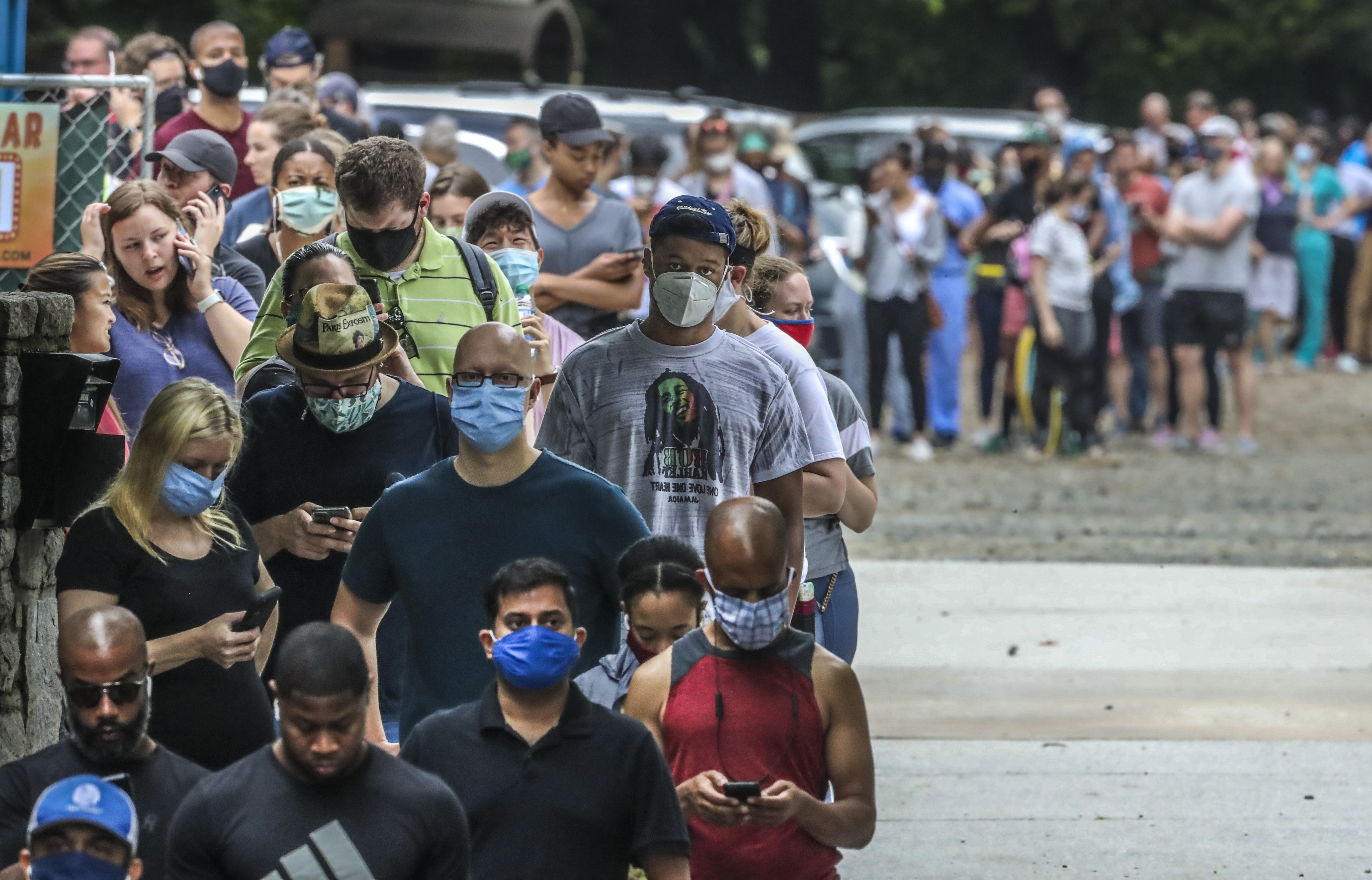 During the June 2020 primary election, some voters in Fulton County waited as long as 2-3 hours in lines such as this one at Park Tavern in Midtown. Although SB 202 addresses long lines at polling sites, the new rules apply only to general elections and not primaries. (JOHN SPINK/JSPINK@AJC.COM)