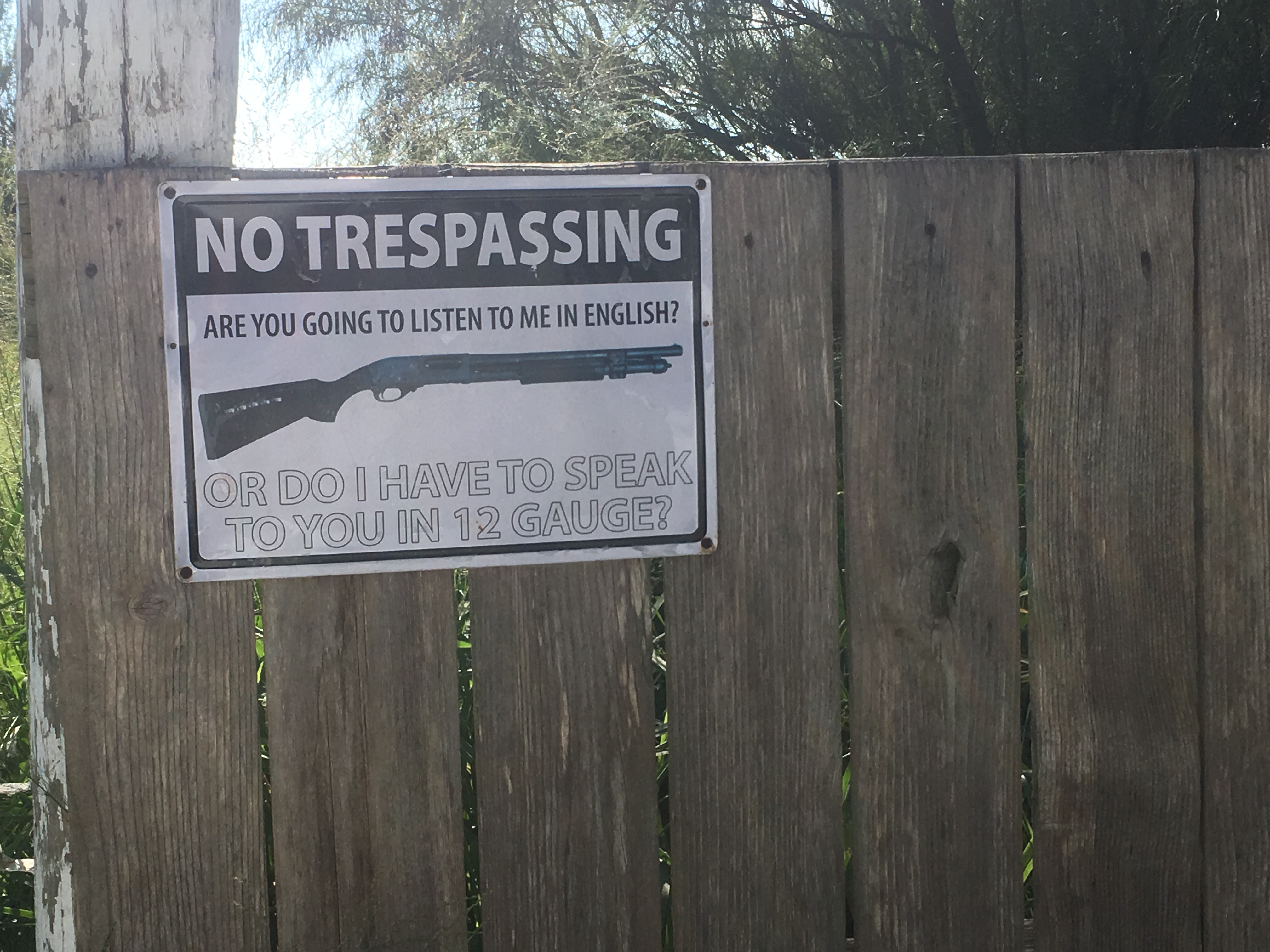 A warning sign on a fence down the road from Reality Winner's family's home. Photo: Jennifer Brett