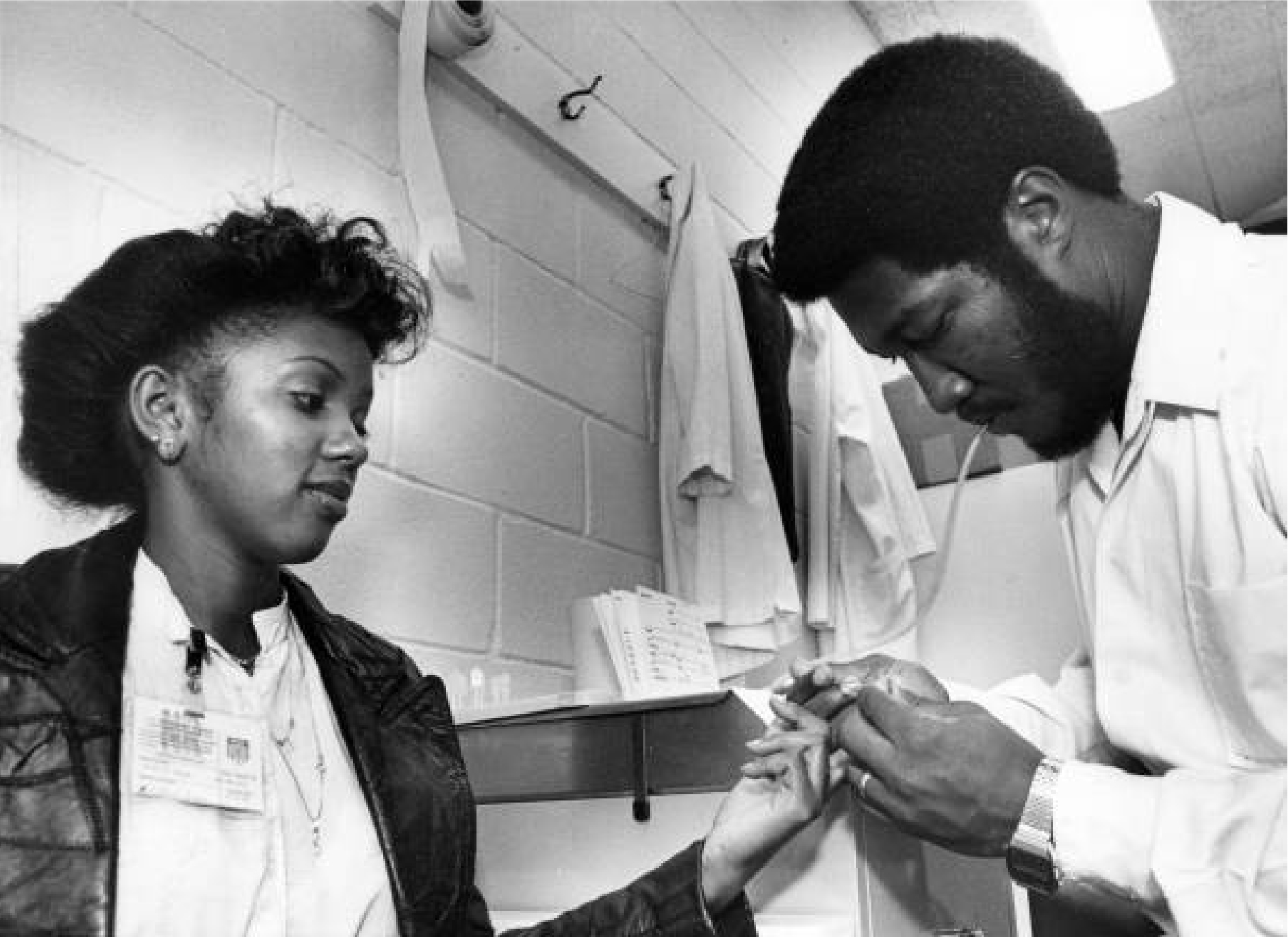 A patient at the Georgia Sickle Cell Foundation gives a sample of her blood to Phillip Oliver, a genetic counselor, so it can be tested in the lab for sickle cell anemia in this 1981 image. (Dwight Ross Jr. / AJC Archive at GSU Library AJCP302-032c)