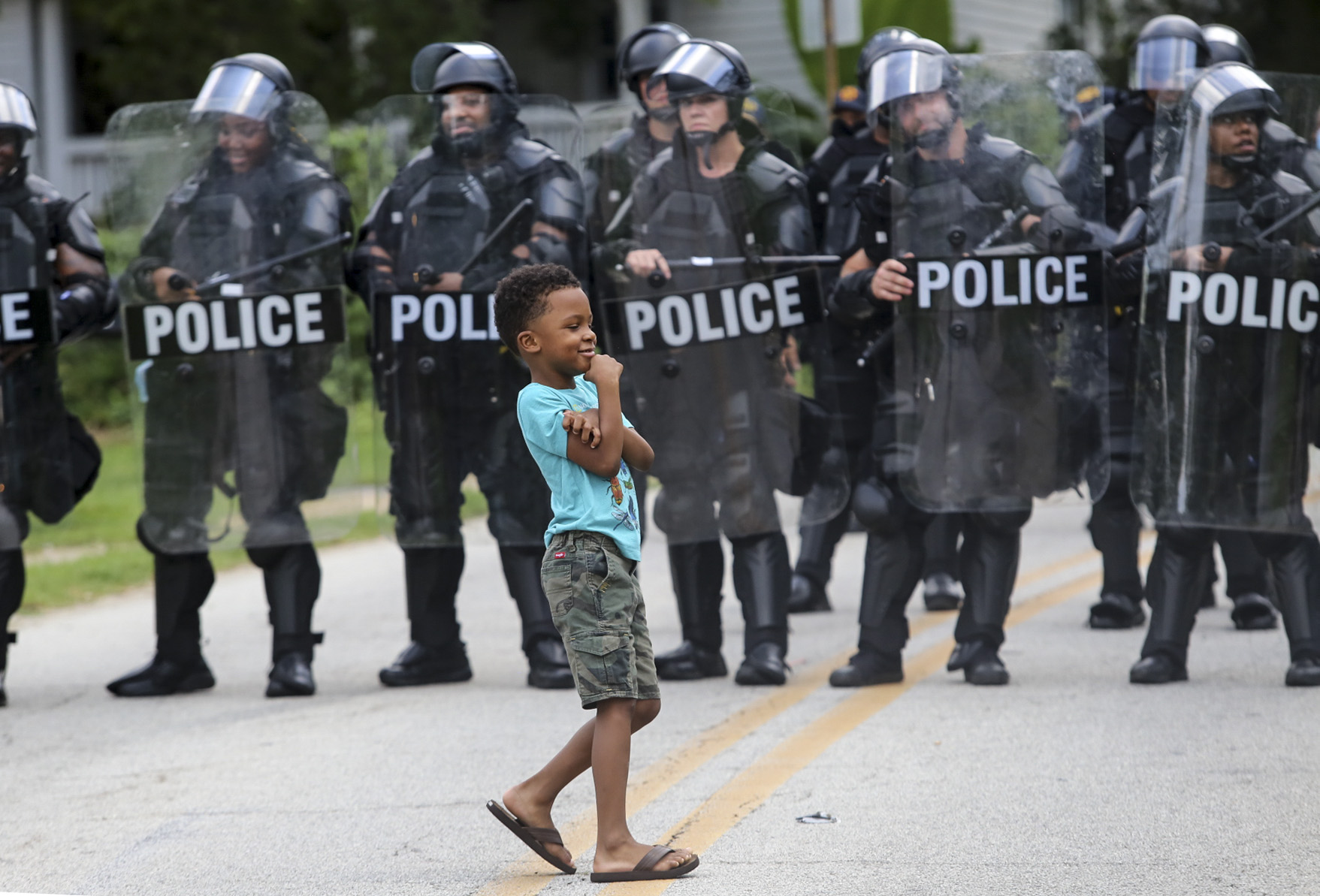 8/15/20 - Stone Mountain, GA - James Armour, 6, looks toward his mom before he talks to police as several far-right groups, including militias and white supremacists, rally Saturday in the town of Stone Mountain, and a broad coalition of leftist anti-racist groups organized a counter-demonstration there after local authorities closed Stone Mountain park. Jenni Girtman for the Atlanta Journal Constitution