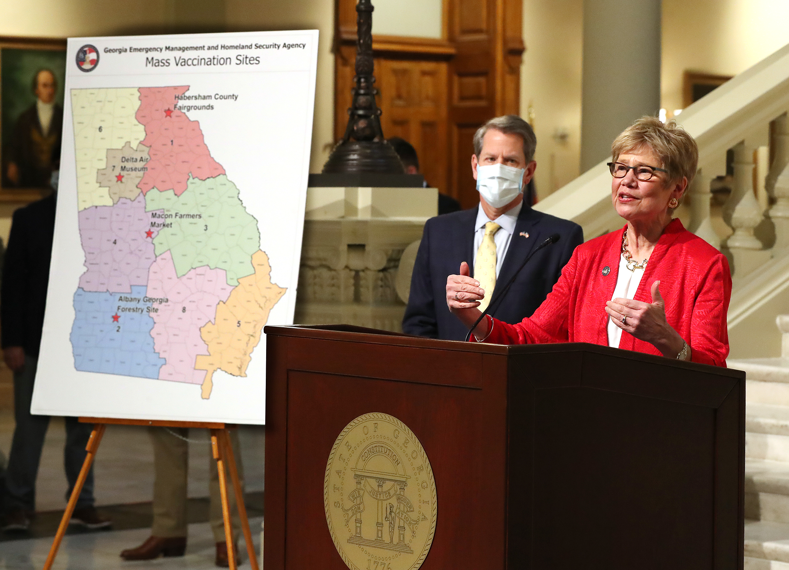 021821 Atlanta: Dr. Kathleen Toomey speaks with Governor Brian P. Kemp looking on during an announcement launching mass vaccination sites amid supply shortage on Thursday, Feb. 18, 2021, in Atlanta. Curtis Compton / Curtis.Compton@ajc.com”