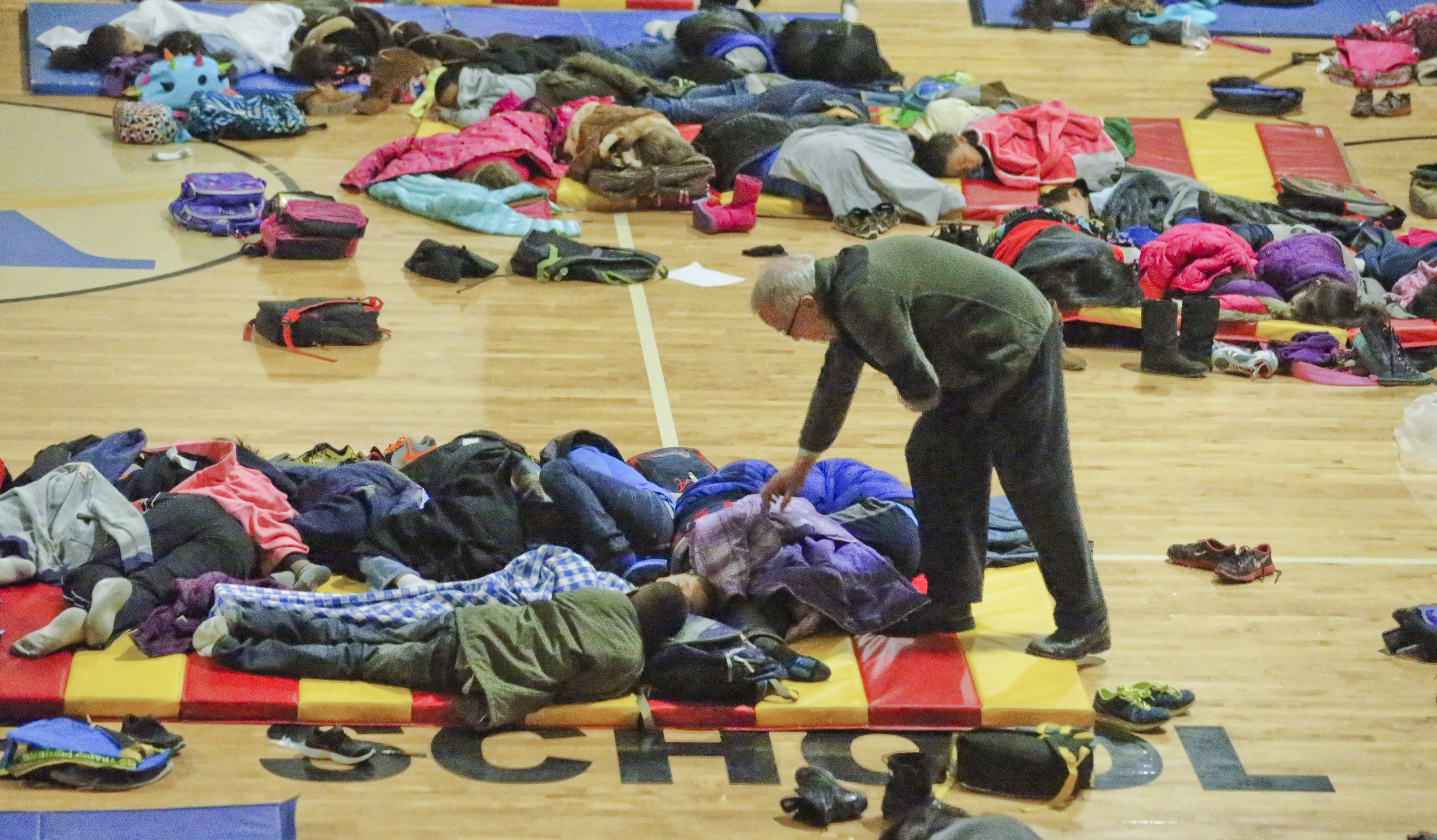 Thousands of schoolchildren, such as these at Atlanta's E. Rivers Elementary School, spent the night in gyms. Others who left on buses wound up stuck in them on gridlocked roadways. JOHN SPINK / JSPINK@AJC.COM