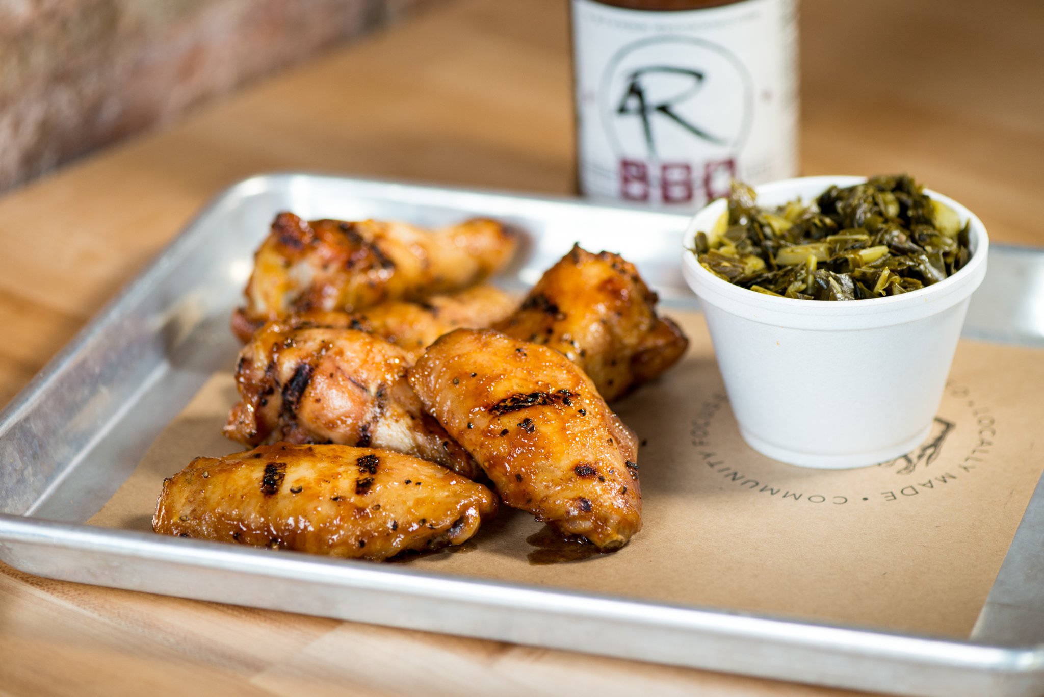 4 Rivers Smokehouse Chicken Wings with signature sauce and side of collards. Photo credit- Mia Yakel.