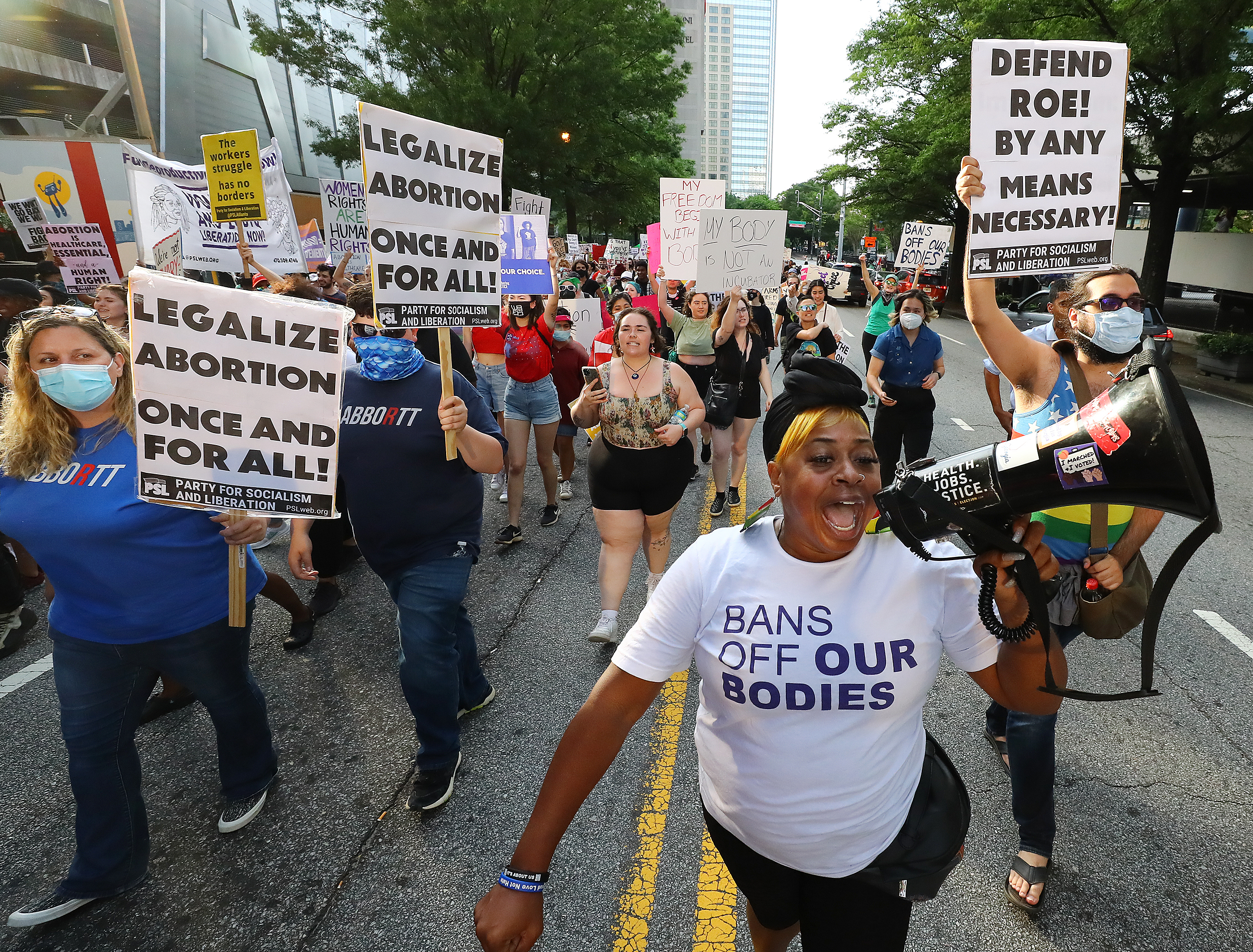 050322 Atlanta: Dozens of protesters march from Centennial Olympic Park to the Georgia Capitol during a rally to defend the right to abortion on Tuesday, May 3, 2022, in Atlanta. “Curtis Compton / Curtis.Compton@ajc.com”