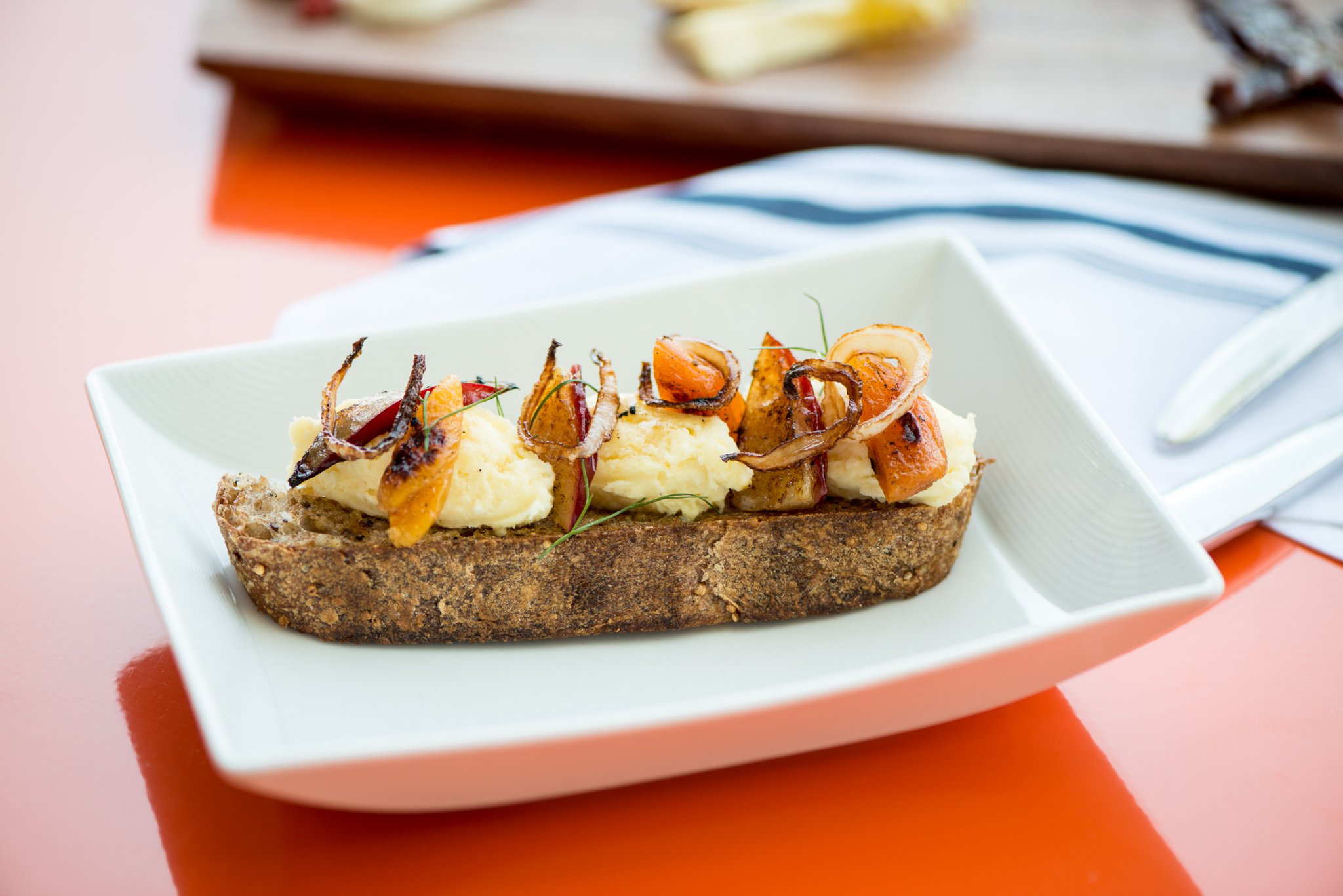 Grilled Apricots, with sunflower sprouts, crisped Vidalia bulb, grapefruit vinaigrette, and whipped Waypoint cheese. Photo credit- Mia Yakel.