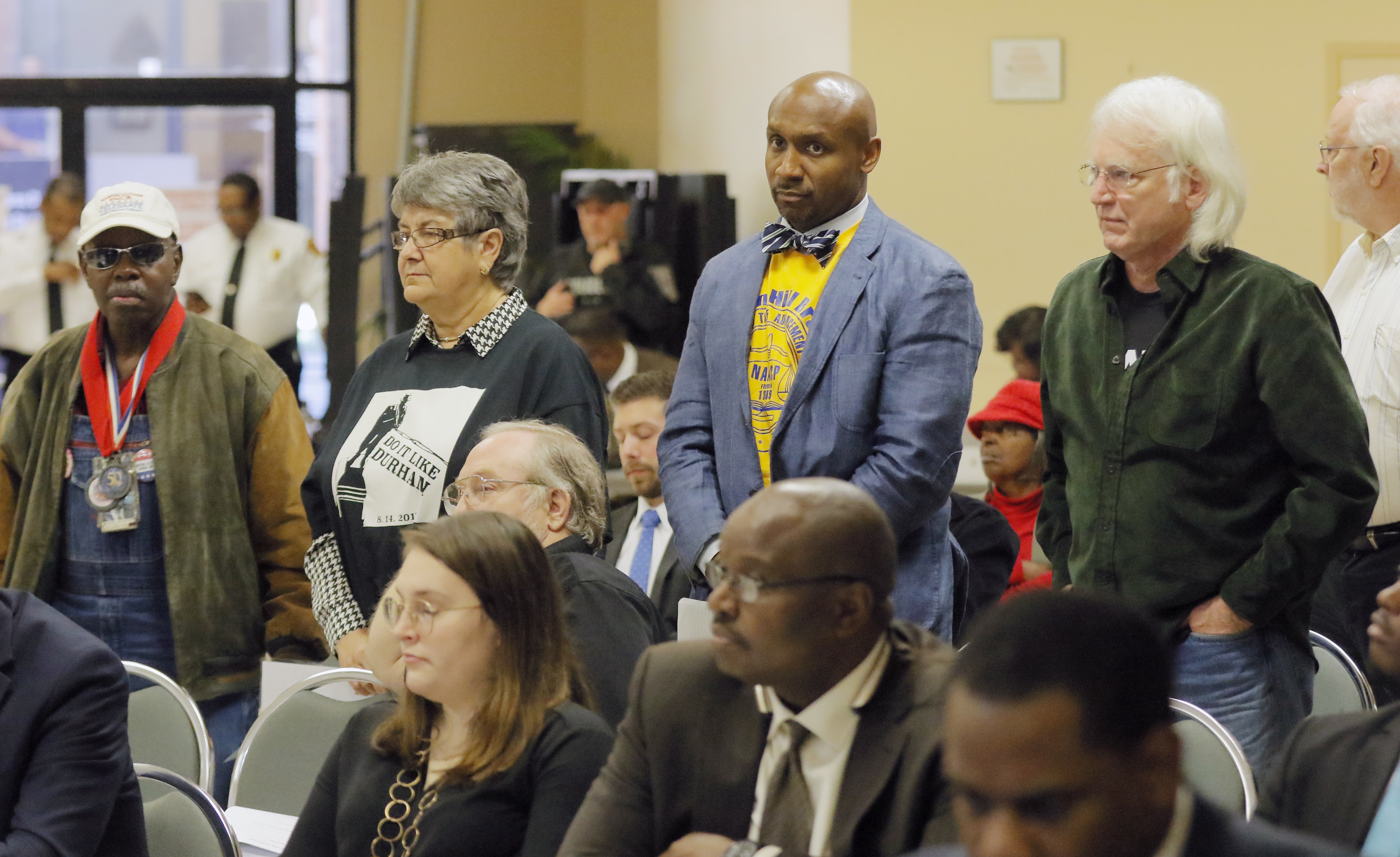 Supporters of removing a Confederate monument from Decatur stand in support of a speaker during public comment at the DeKalb County Commission. The commission is expected to vote to explore removing the monument. The vote wouldn't remove the monument immediately; rather, it would start an investigation into potential loopholes in state law allowing the county to take action. BOB ANDRES /BANDRES@AJC.COM