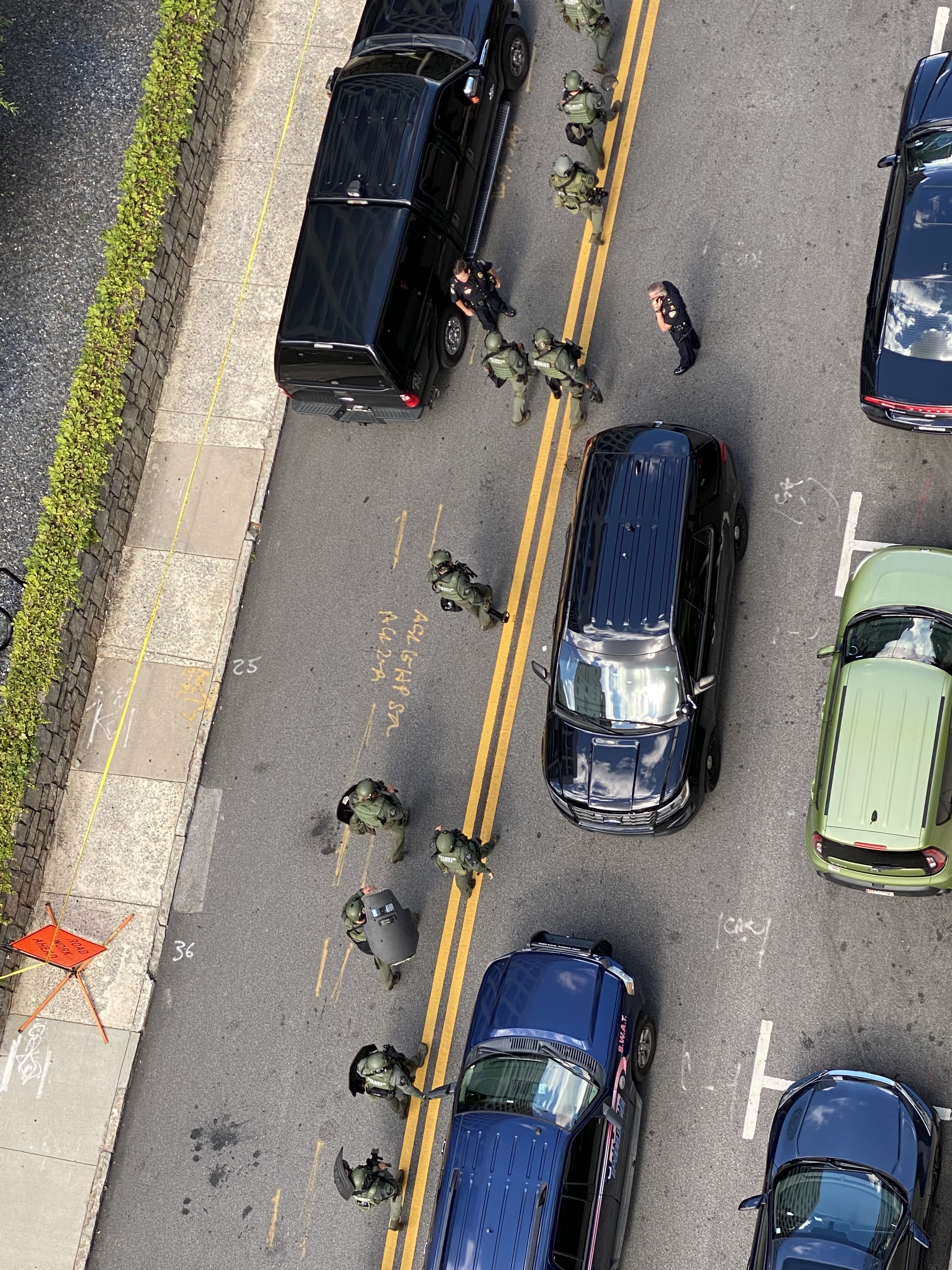 Midtown residents looked on from their apartment windows as police flooded Peachtree Street following the officer's shooting.