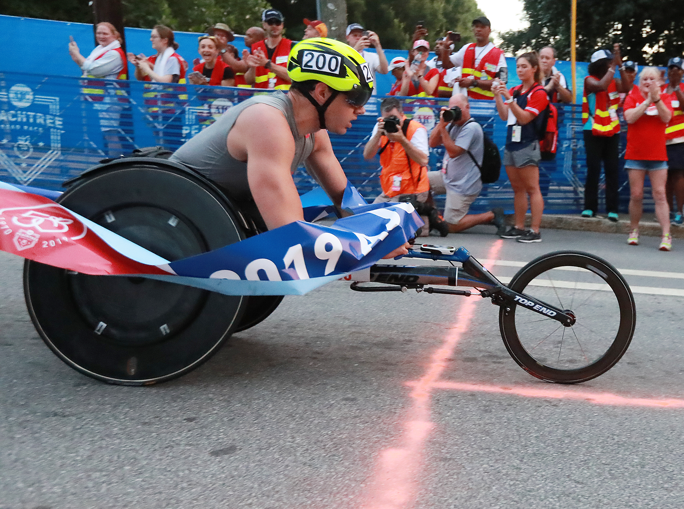 Daniel Romanchuk wins the men's wheelchair race in record time and a $50,000 bonus during the 50th AJC Peachtree Road Race on Thursday, July 4, 2019, in Atlanta. Curtis Compton/ccompton@ajc.com