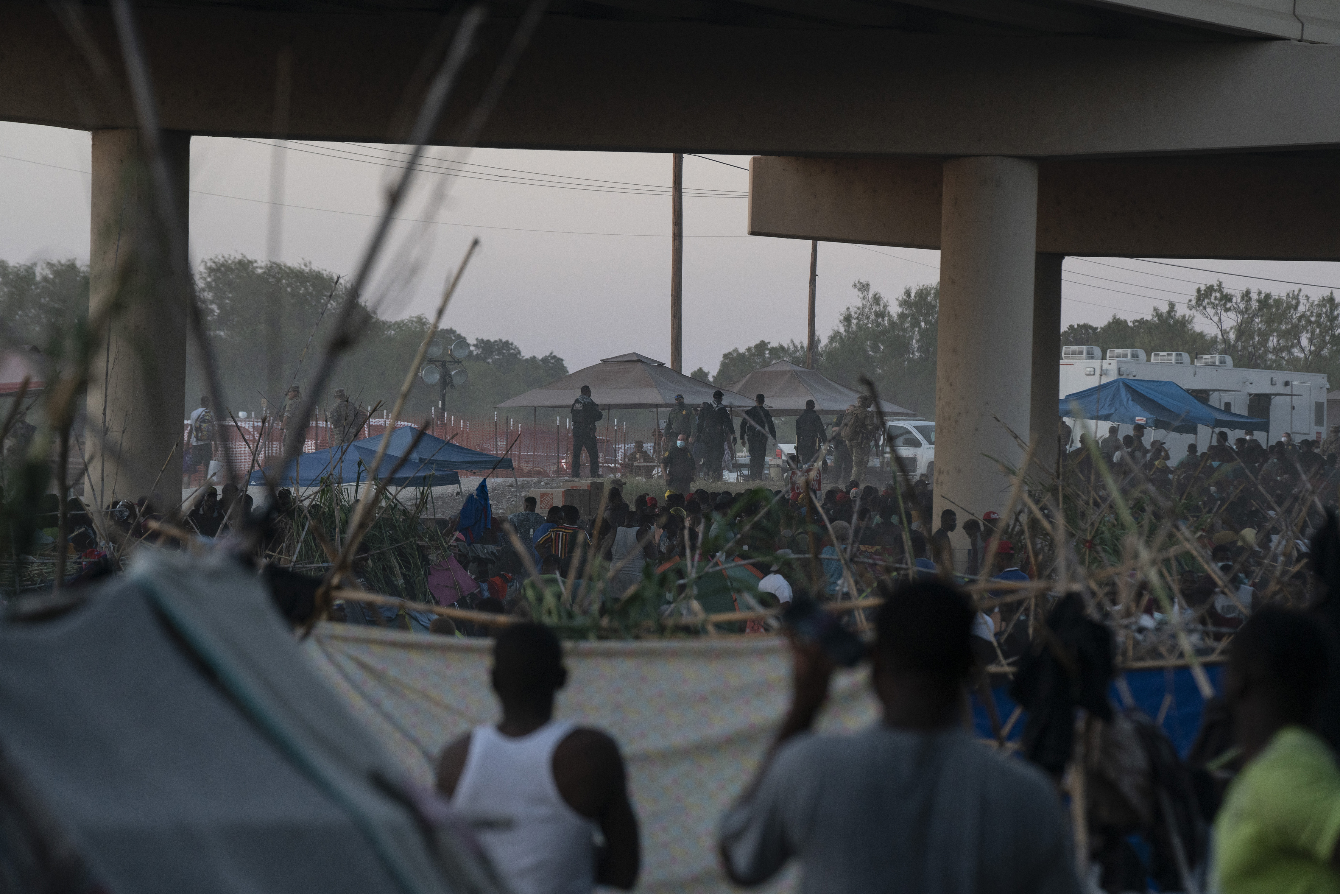 FILE - Migrants near the Del Rio International Bridge in Del Rio, Texas, Sept. 17, 2021. The U.S. and Mexico began overhauling an aged security agreement on Friday to better confront the flow of criminal activity between the two nations, but officials at the high-level talks conspicuously sought to avoid focusing on the ever-growing migrant crisis on their shared border. (Verónica G. Cárdenas/The New York Times)