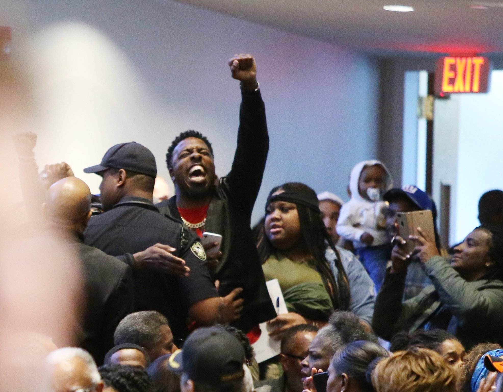 People protest the way the death of 21-year-old Jimmy Atchison was handled by officials at a town hall hosted by Atlanta Mayor Keisha Lance Bottoms at Cascade United Methodist Church in Atlanta, Georgia on Tuesday, March 19, 2019. EMILY HANEY / emily.haney@ajc.com