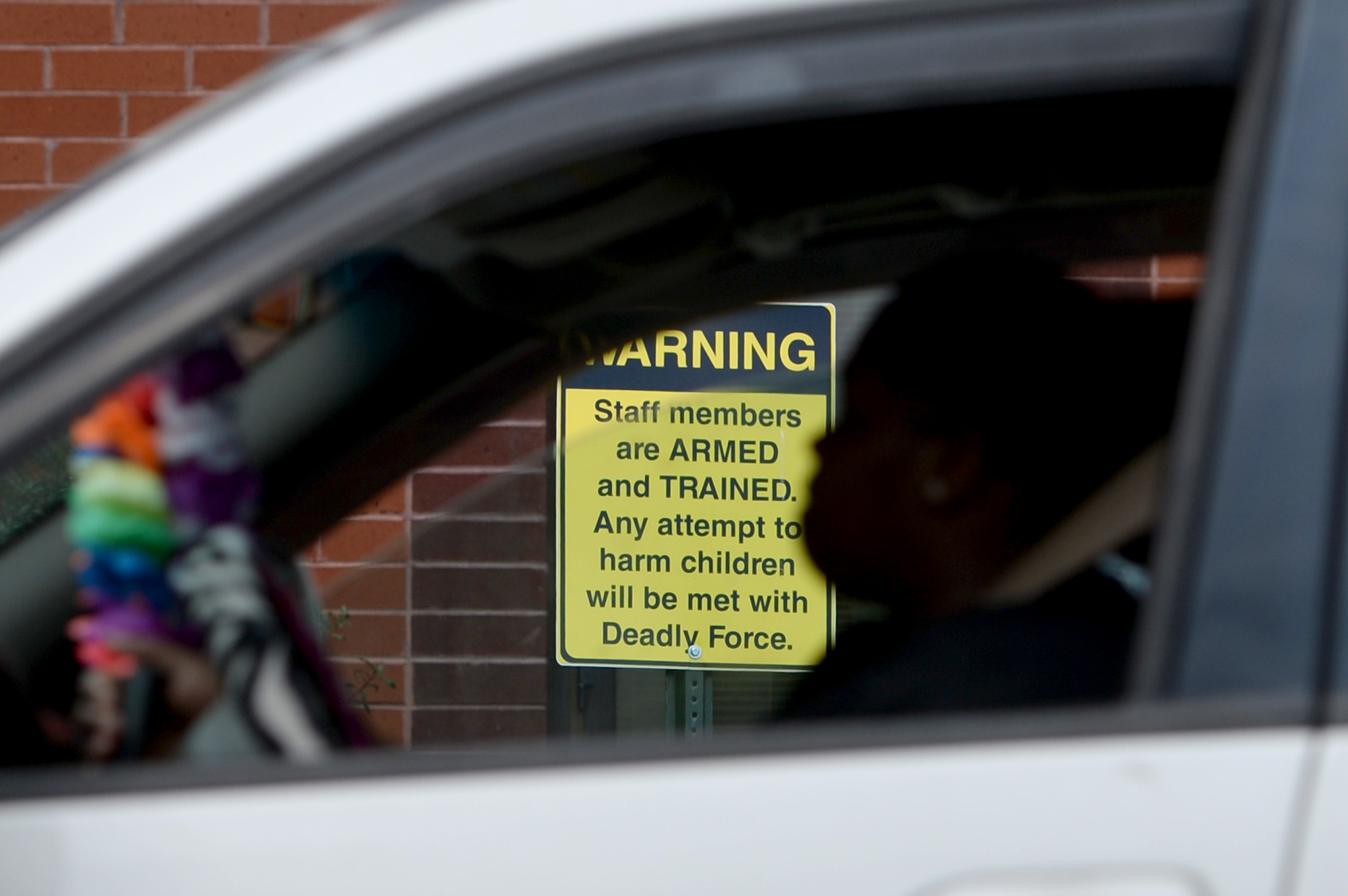 03/25/19 - Dublin - Shamecca Plummer, a parent of students who attend East Laurens Middle-High School, waits on Monday in her car for her kids to get out of school. The school has posted signs to let visitors know staff members are carrying weapons. Plummer says she doesn't think firearms have any place in schools. "I don't think it's good because you never know. A kid might could still find a weapon and use it on the teacher or whoever," she says. "It's really dangerous to have it on campus anyway." Jenna Eason for The Atlanta-Journal Constitution.