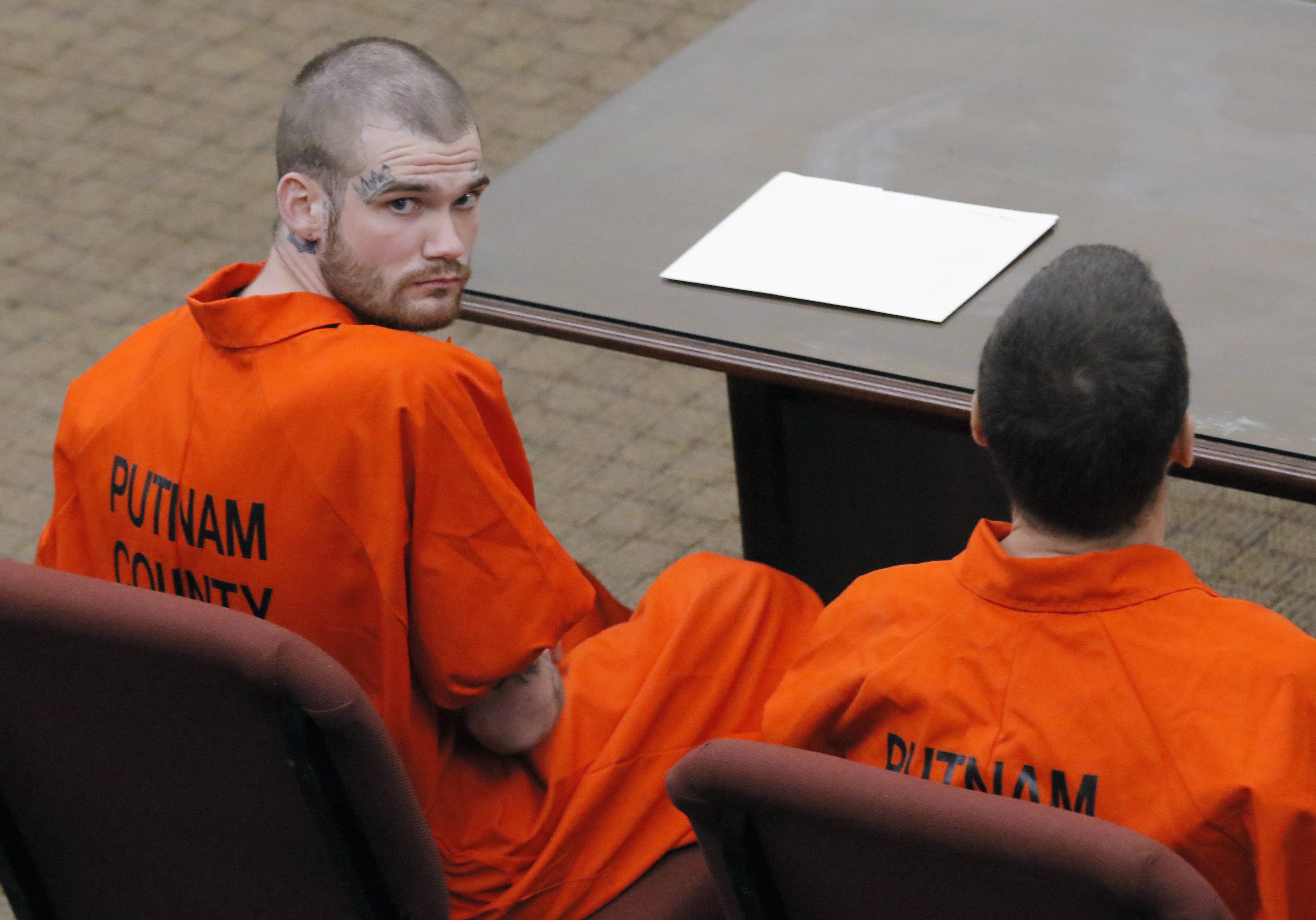 Ricky Dubose (left), looking toward the balcony at the Putnam County courthouse during a hearing in June 2017. He and his co-defendant, Donnie Russell Rowe (right), are accused of killing two prison guards during an escape.