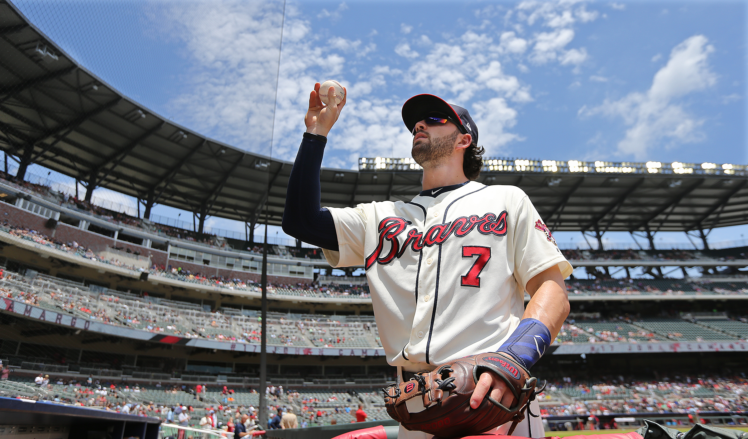 Atlanta Braves player Dansby Swanson tosses a ball to fans at SunTrust Park. / Curtis Compton/ccompton@ajc.com