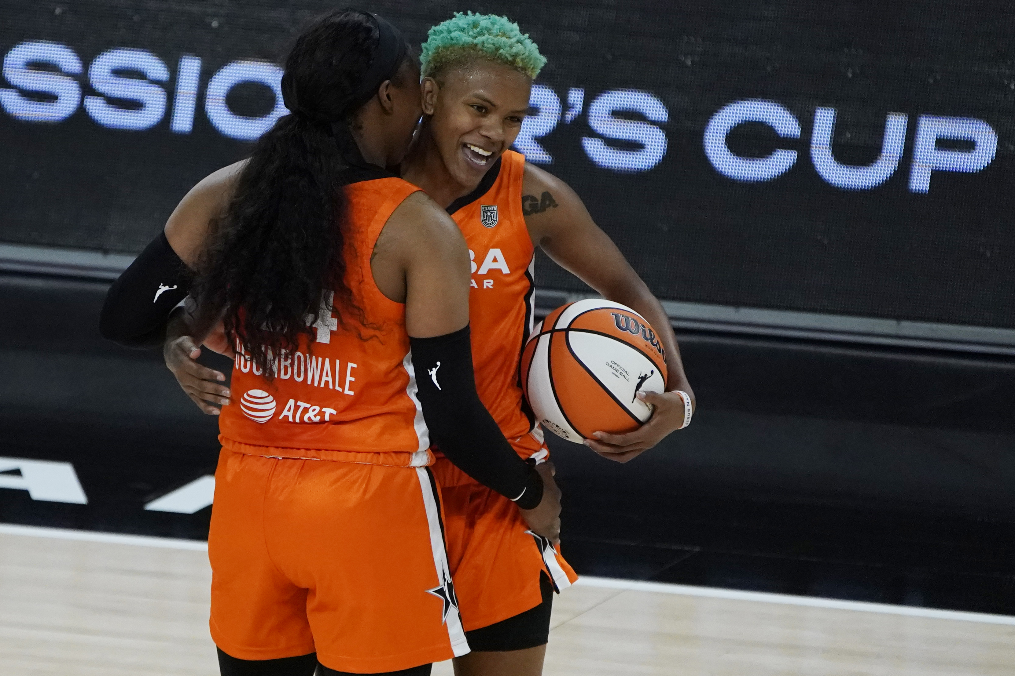 Team WNBA's Arike Ogunbowale, left, and Courtney Williams celerate after defeating United States in a WNBA All-Star basketball game, Wednesday, July 14, 2021, in Las Vegas. (AP Photo/John Locher)