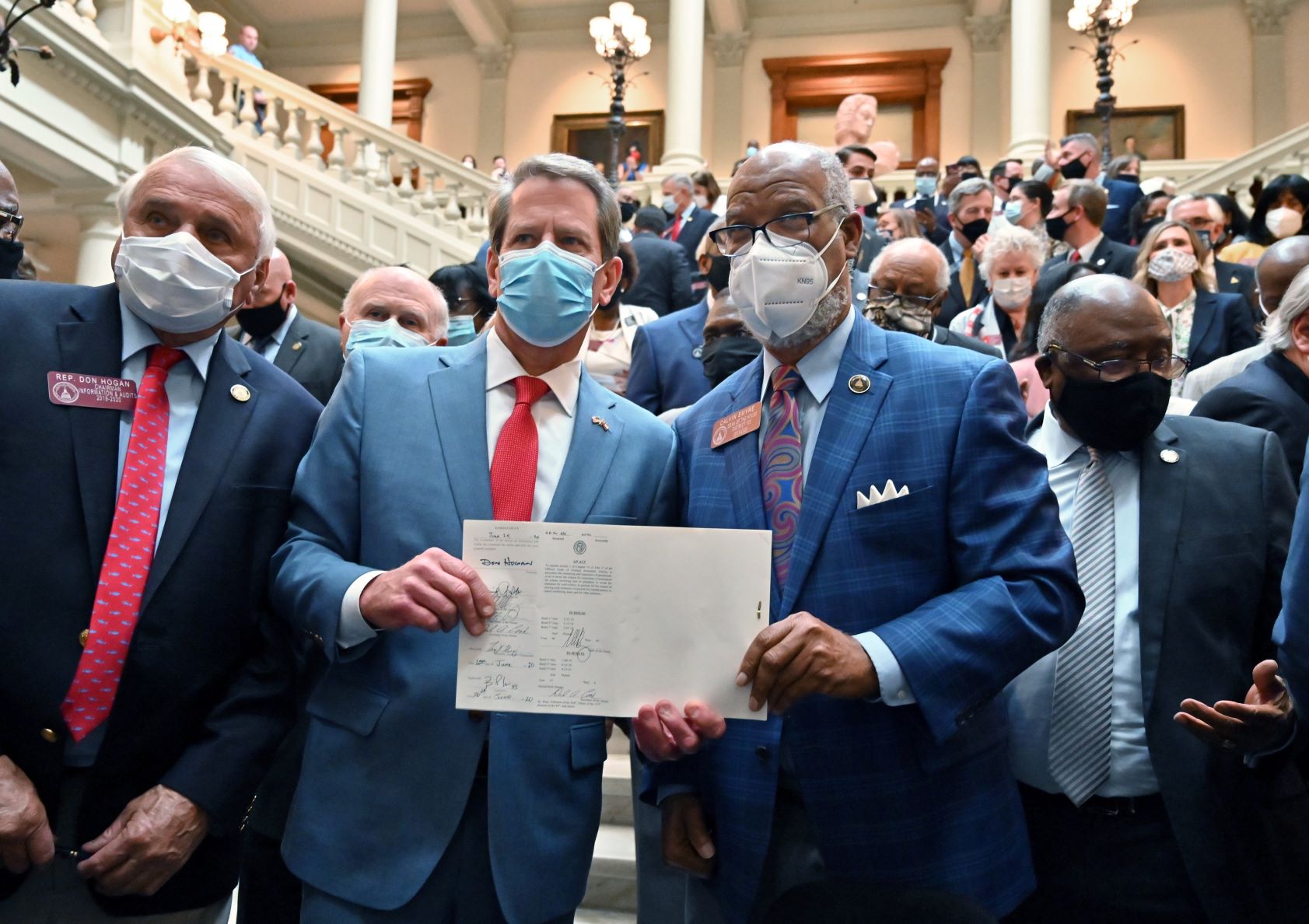 June 26, 2020 Atlanta - Gov. Brian Kemp and Rep. Calvin Smyre hold the signed HB 426, hate-crimes legislation, on the last day of the legislative session at Georgia State Capitol on Friday, June 26, 2020.. (Hyosub Shin / Hyosub.Shin@ajc.com)
