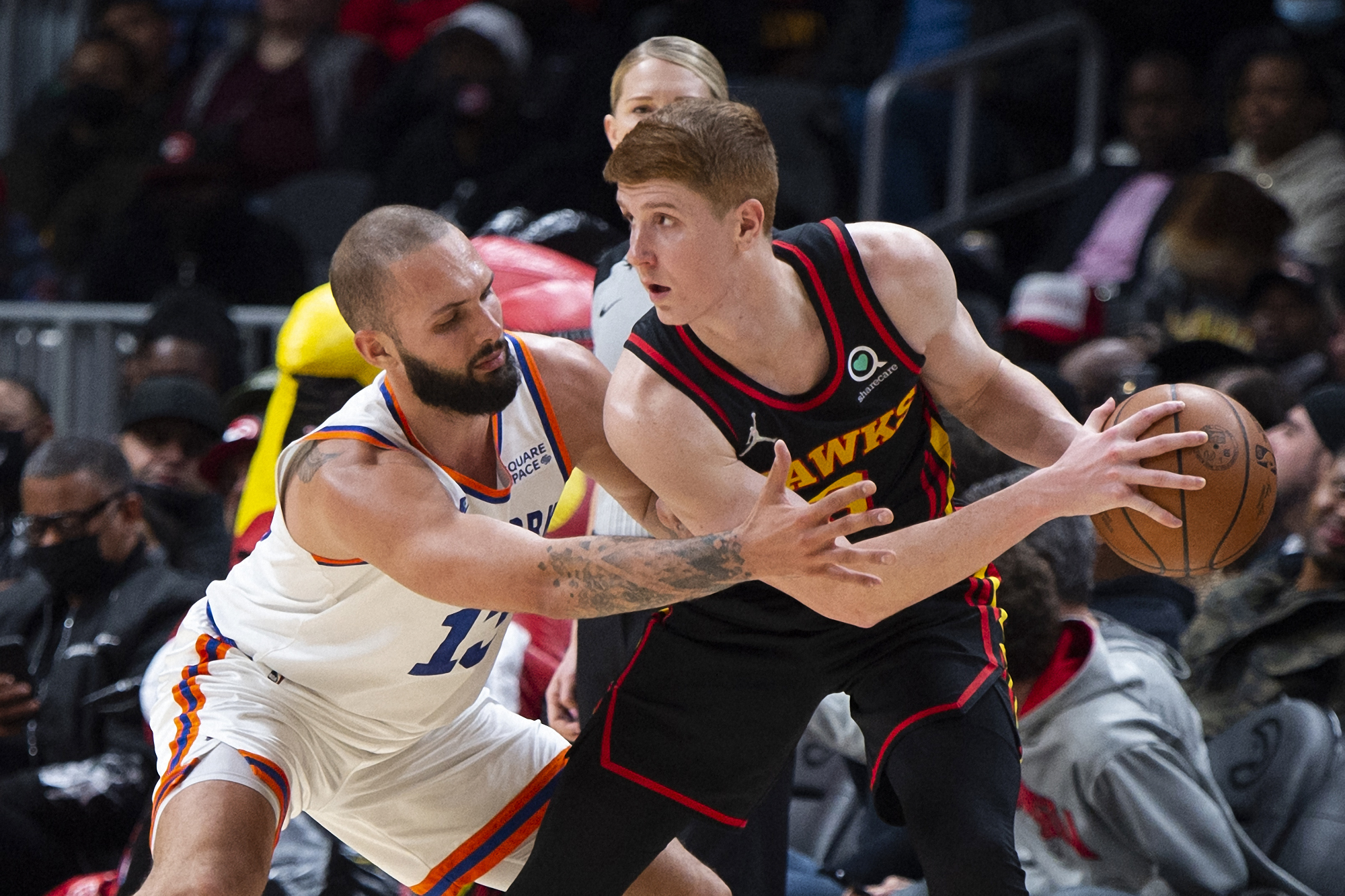 New York Knicks guard Evan Fournier (13) defends Atlanta Hawks guard Kevin Huerter (3) during the second half of an NBA basketball game Saturday, Nov. 27, 2021, in Atlanta. (AP Photo/Hakim Wright Sr.)