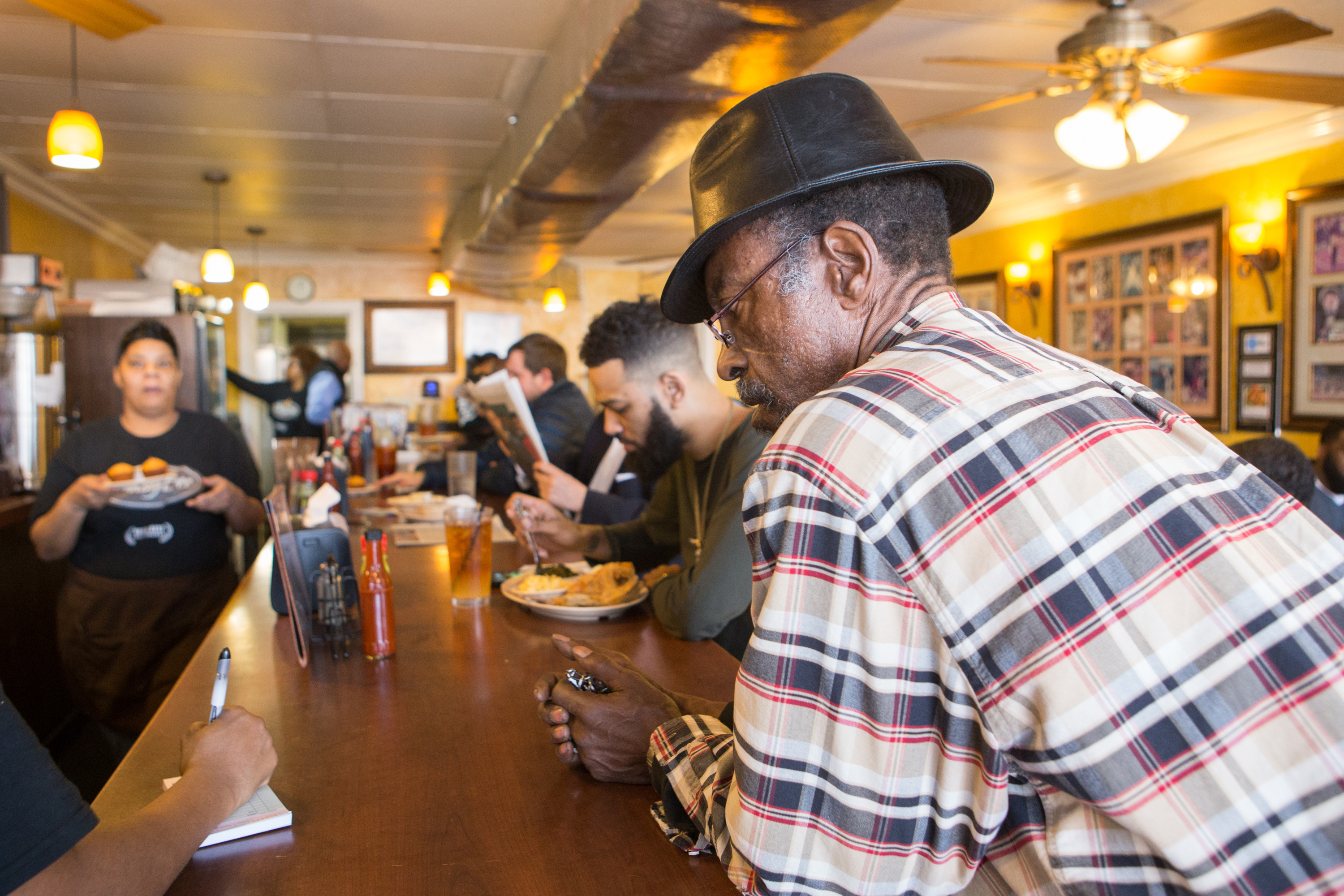 Johnny Scott, a regular at The Busy Bee Cafe, orders a Ox Tails to go at the restaurnt on Martin Luther King Jr. Dr. NE. The historic soul food restaurant opened in 1947. (Jenni Girtman/ Atlanta Event Photography)