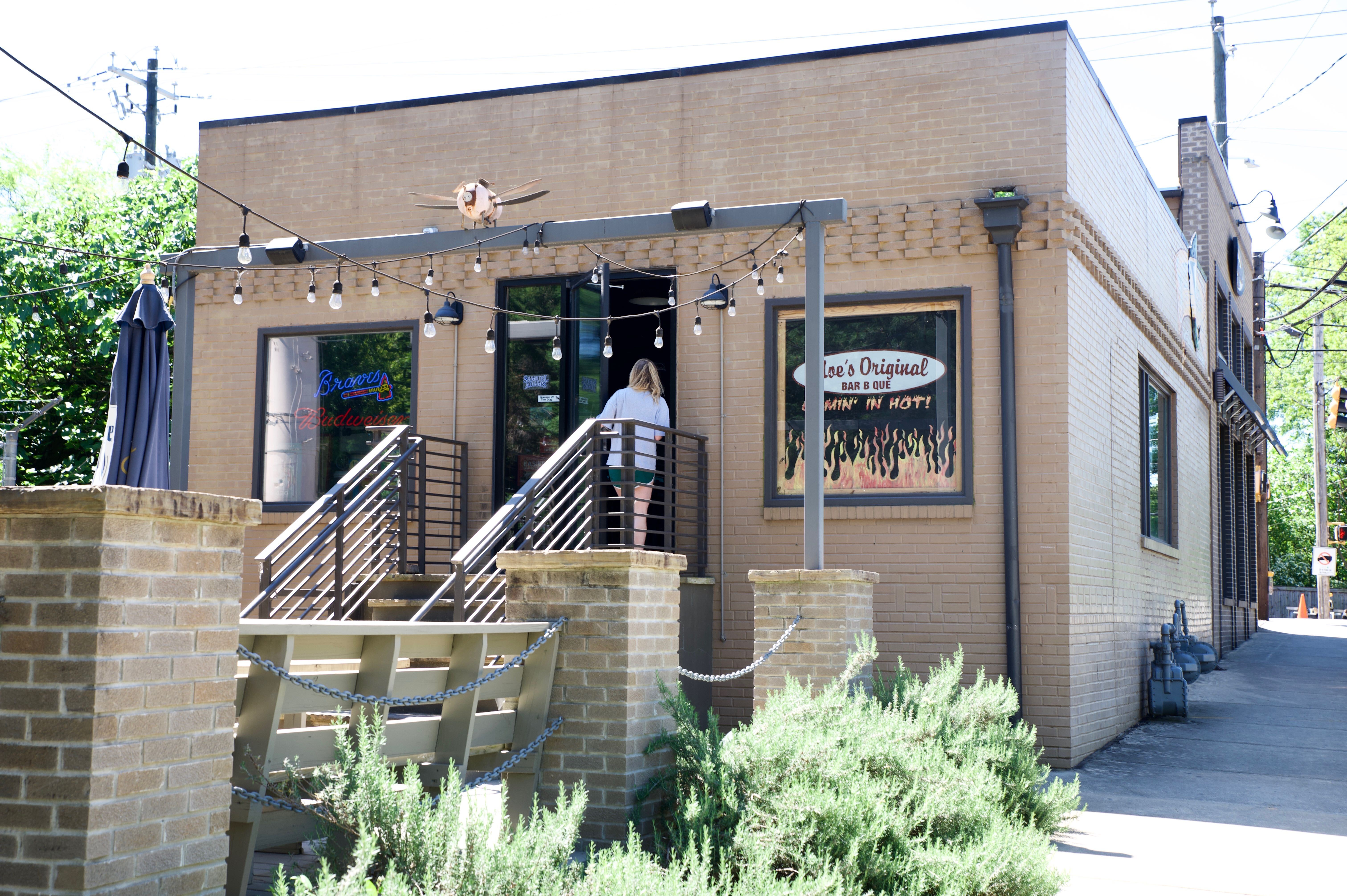 A customer enters Moe’s Original BBQ Monday.