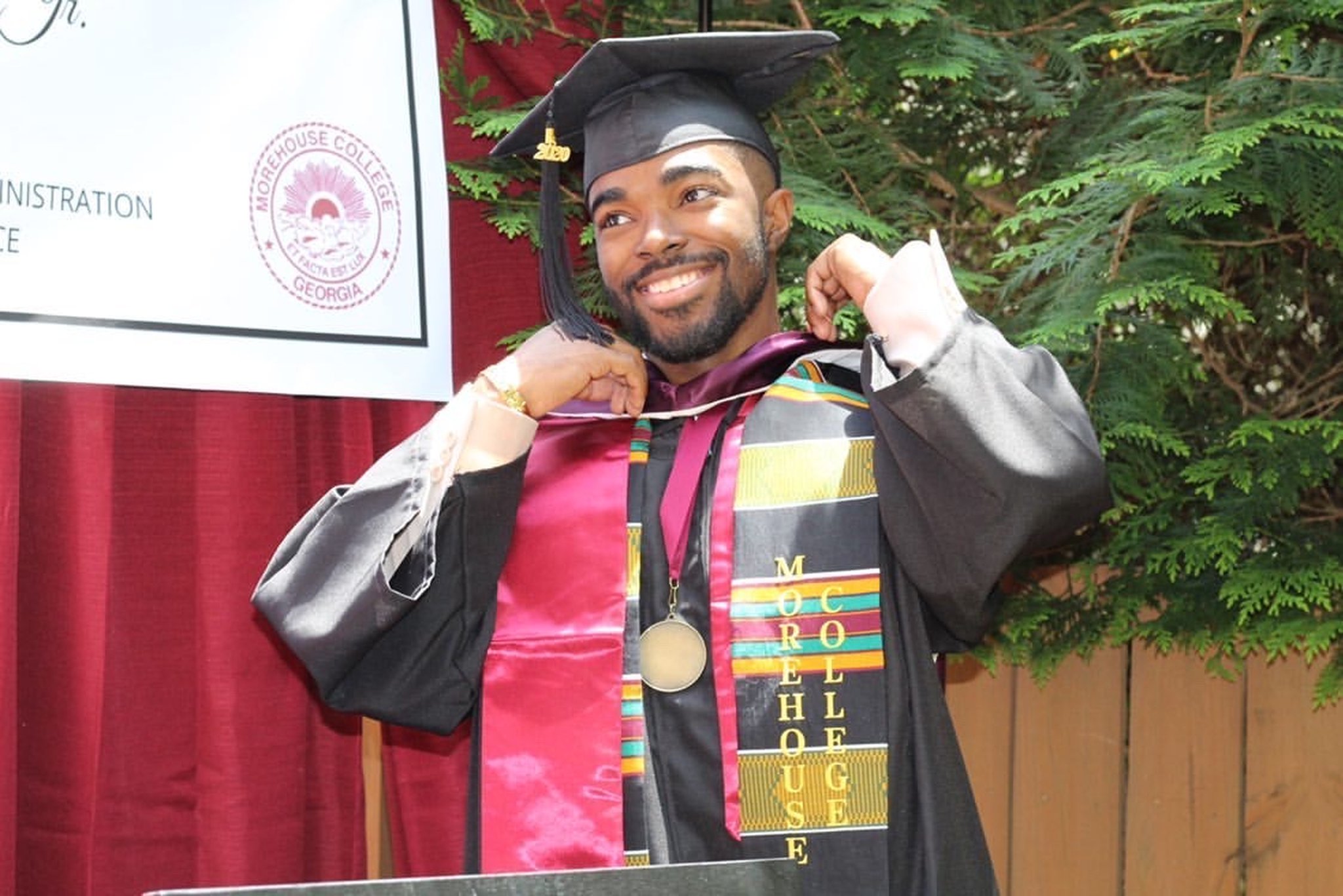 Morehouse College graduate Terrell Jones Jr., 21, is dressed in his cap and gown after a commencement ceremony organized by his family in their backyard. The celebration included a surprise appearance by his father, a U.S. Army chaplain stationed in Maryland.