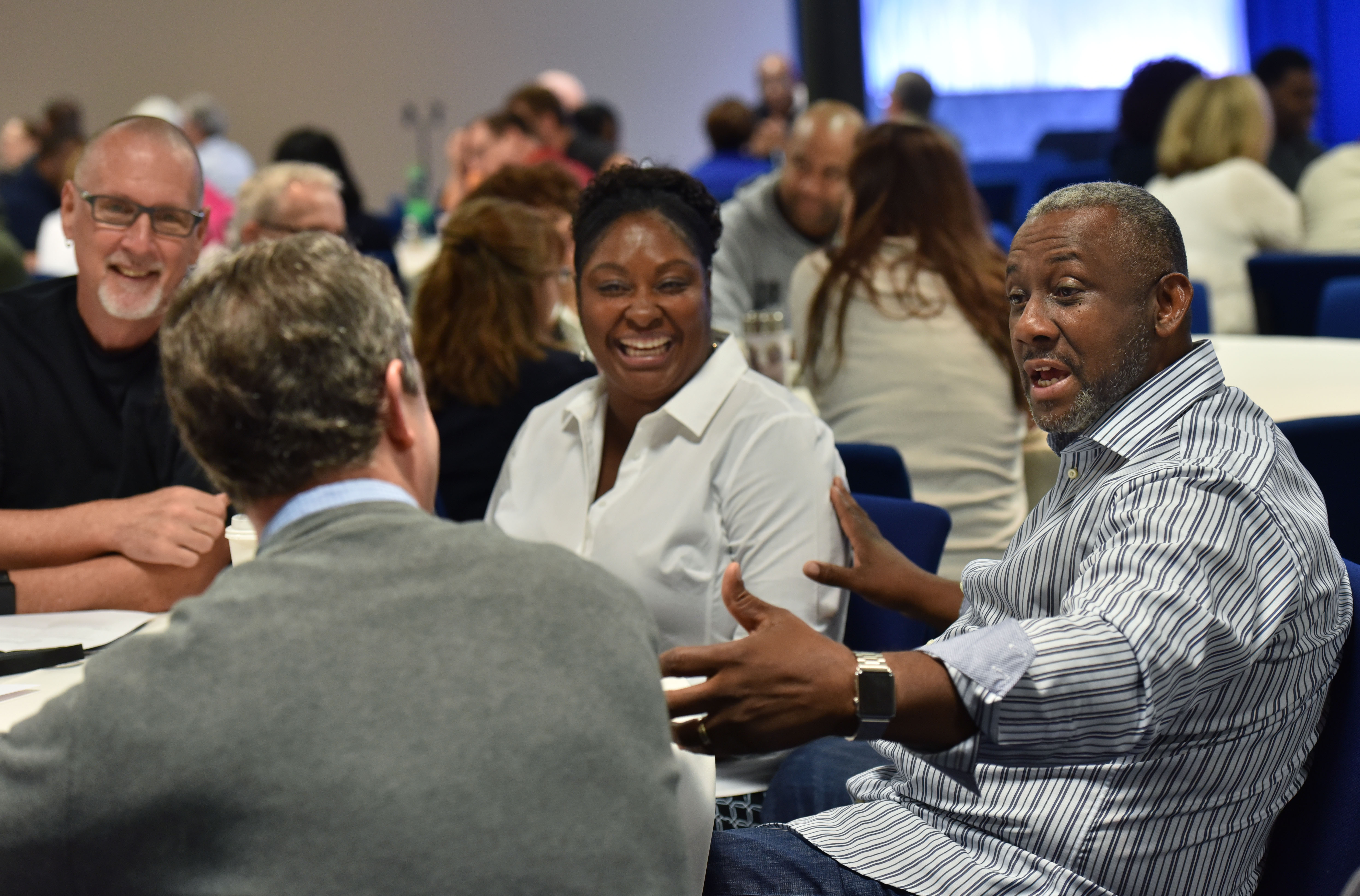 Melvin Kinard (right) talks to Mike Moss (foreground) as Stephen Gilkenson (left) and Corliss Kinard react during a "Grace and Race" seminar at Eagles Nest Church in Roswell on Saturday, May 6, 2017. HYOSUB SHIN / HSHIN@AJC.COM