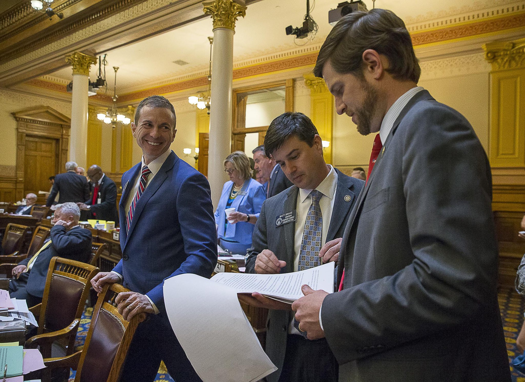 Georgia Senator Greg Dolezal (left), Sen. Matt Brass (center) and Sen. Brian Strickland (right), talk among themselves in the Senate chambers during Sine Die, the last day of the 2019 legislative session, at the Georgia State Capitol in Atlanta, Tuesday, April 2, 2019. (ALYSSA POINTER/ALYSSA.POINTER@AJC.COM)