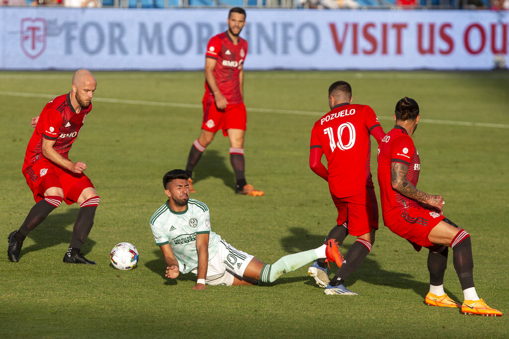 Atlanta United midfielder Marcelino Moreno, center, is fouled by Toronto FC midfielder Alejandro Pozuelo (10) during the first half of an MLS soccer match Saturday, June 25, 2022, in Toronto. (Chris Young/The Canadian Press via AP)