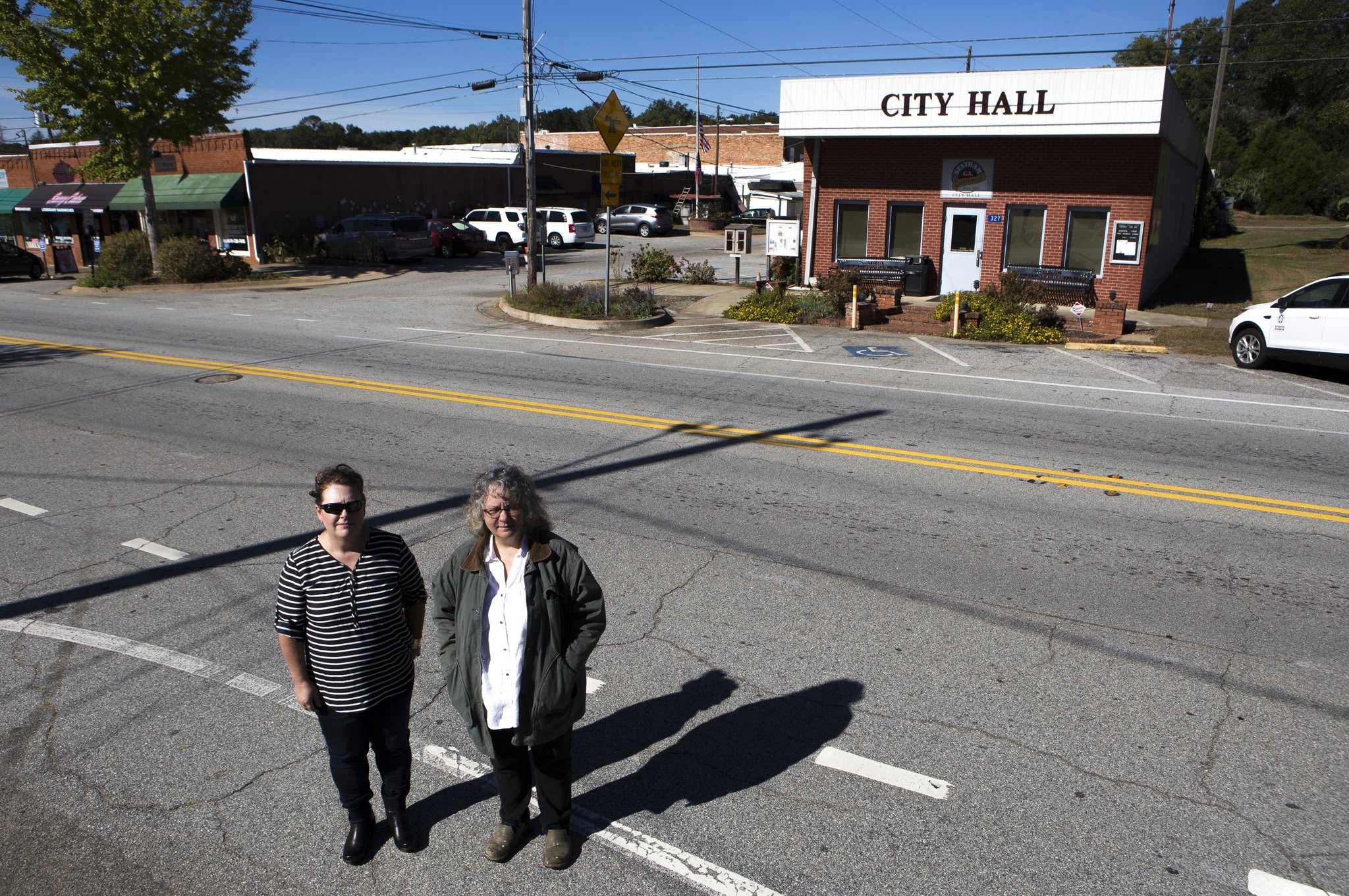 10-24-18 - Statham, GA - Catherine Corkren (left), 47, of Atlanta, Ga., and Sondra Moore, 47, of Hoschton, Ga., pose for a portrait across the road from Statham City Hall in Statham, Ga., on Wednesday, Oct. 24, 2018. (Casey Sykes for The Atlanta Journal-Constitution)