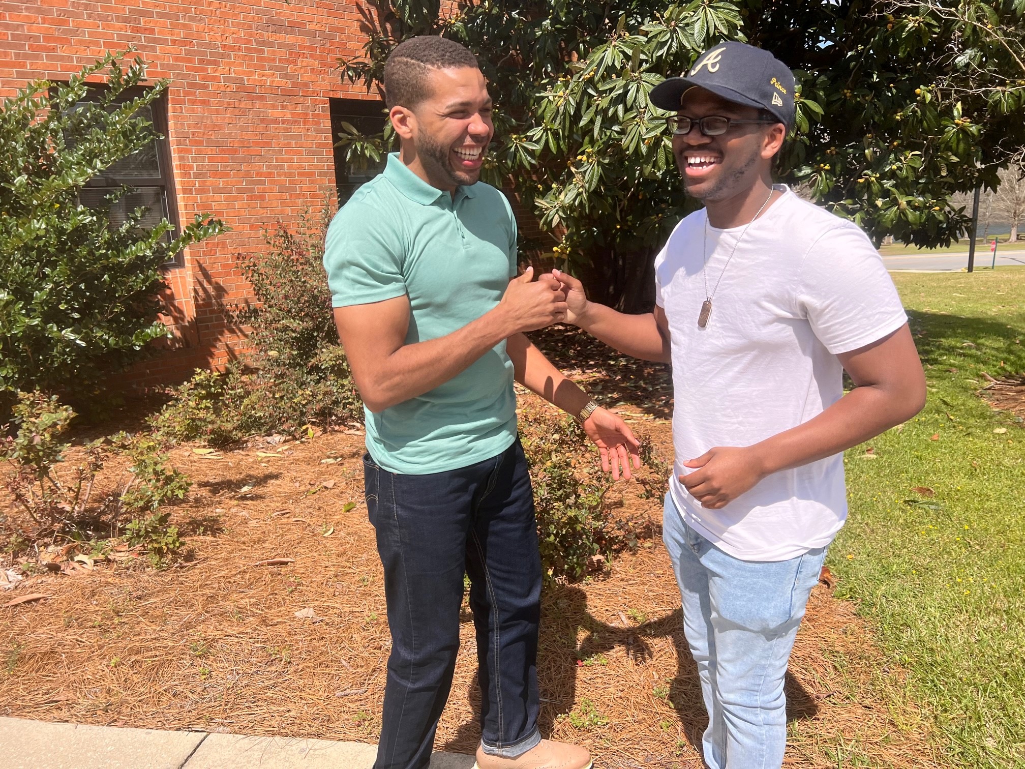 East Georgia State College professor Antré Drummer shares a laugh with student Aaron Penn. Drummer has become a mentor to Penn, 21, an aspiring film producer. College administrators say such relationships are important to help students succeed at the small school. (Eric Stirgus / Eric.Stirgus@ajc.com)