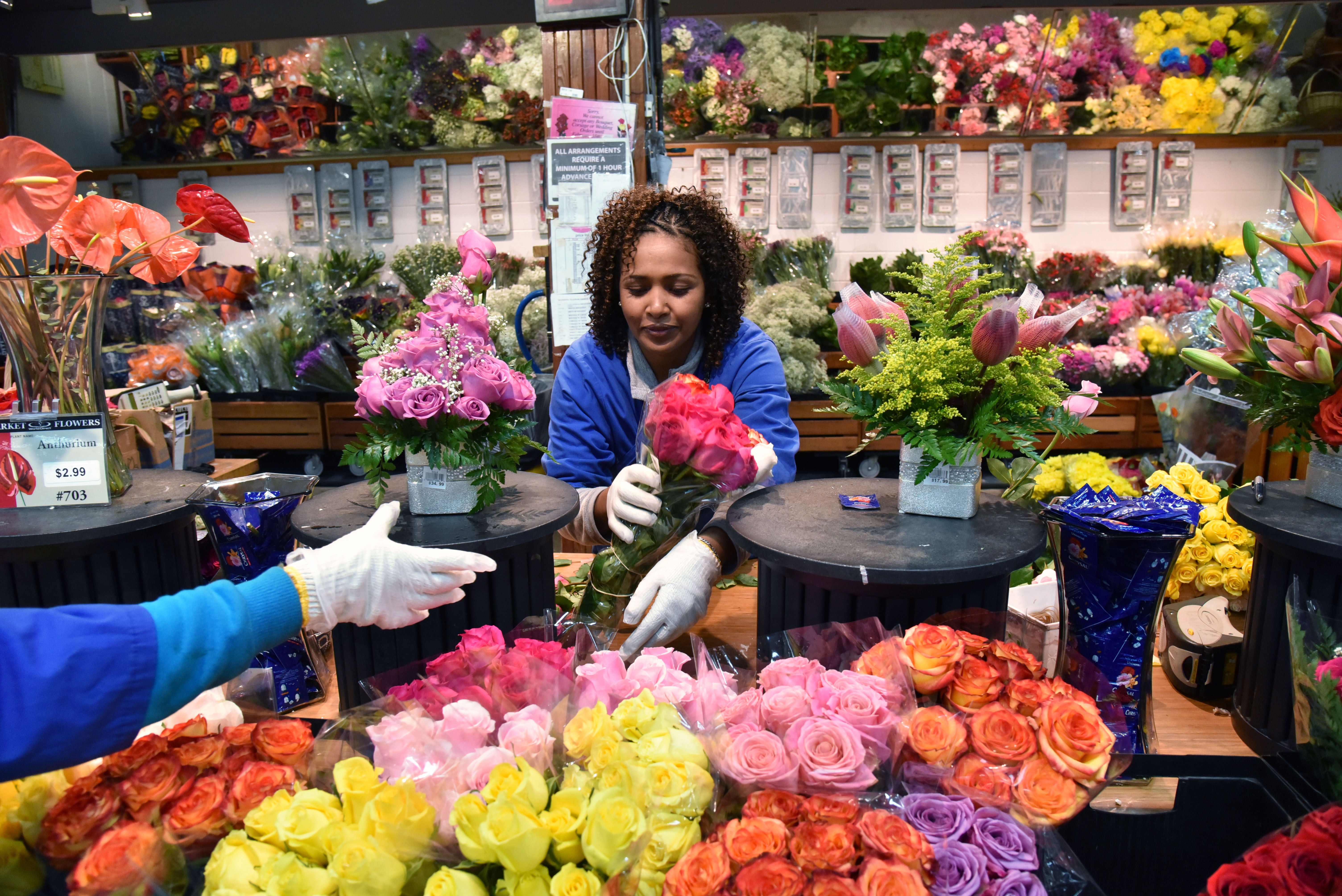 Hawilt Haile works in the floral section at DeKalb Farmers Market on Friday, February 24, 2017.