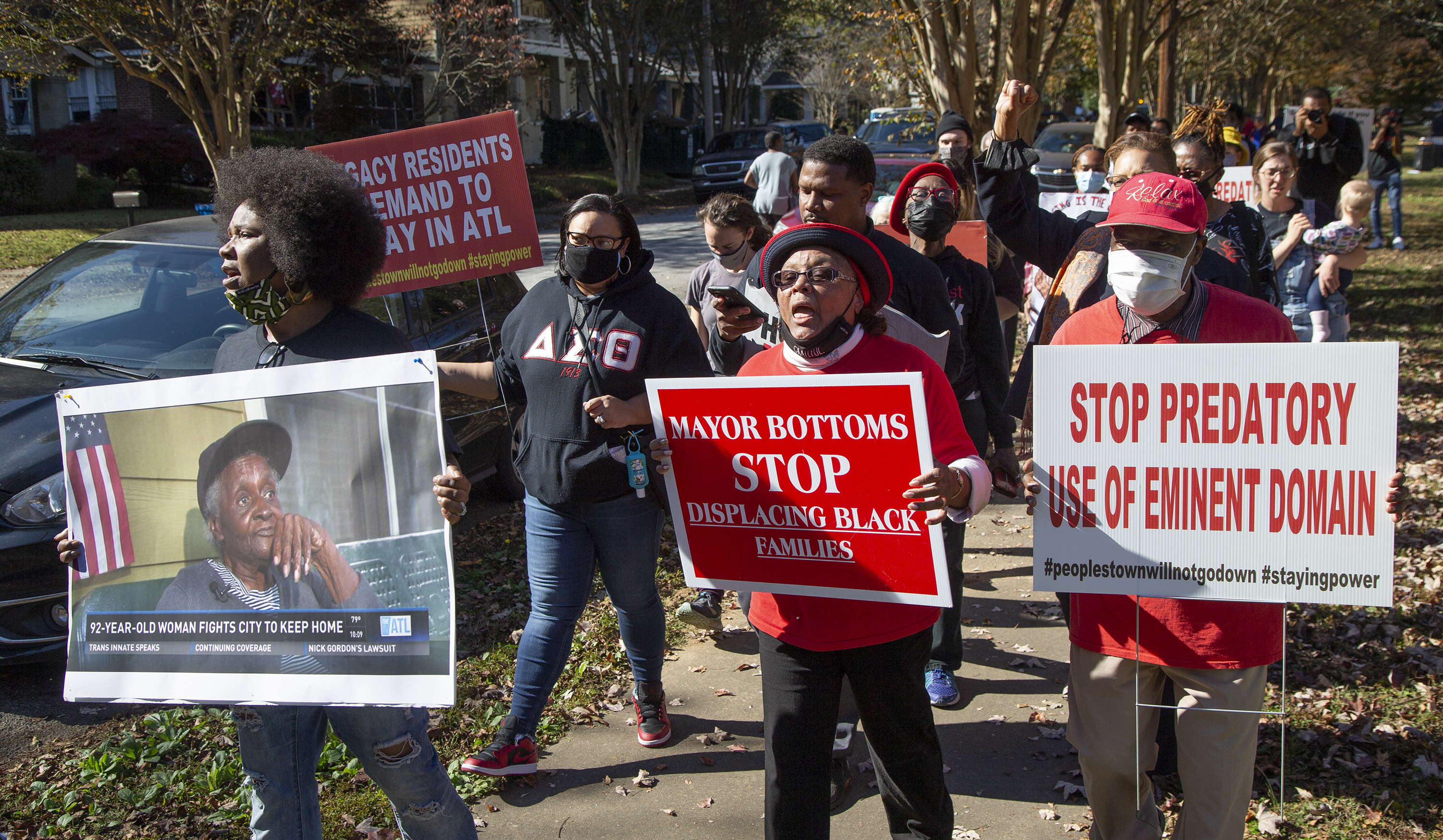 Tanya Washington (left) marches the block in Peoplestown with Bertha and Robert Darden after an rally last year. Dickens has pledged to work with the residents to help them stay in their homes after previous administrations filed evictions. (Phil Skinner for The Atlanta Journal-Constitution)
