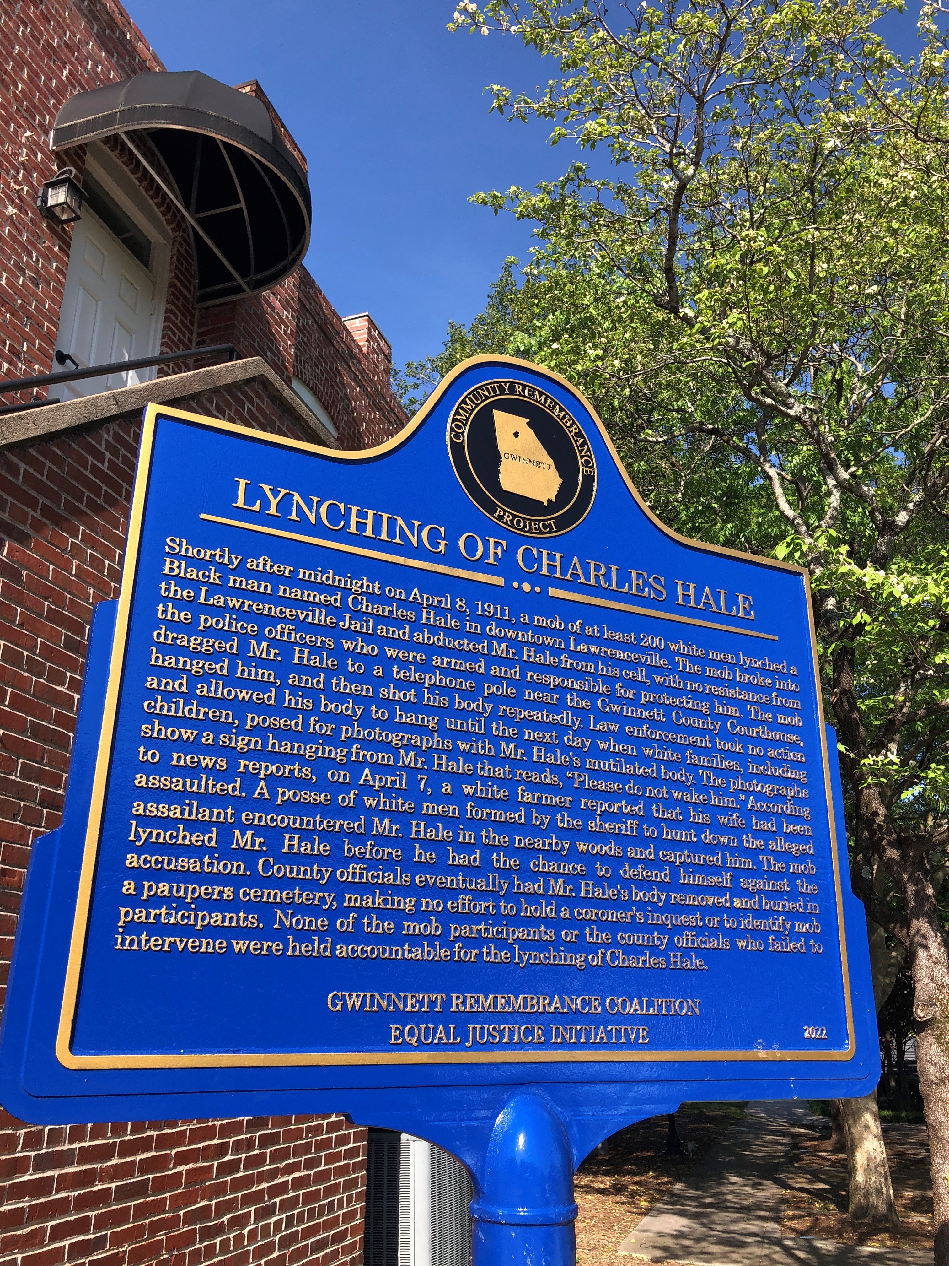 A plaque to commemorate Charles Hale stands where he was lynched in 1911, on the same corner of Lawrenceville square where a monument to the Confederacy once stood.