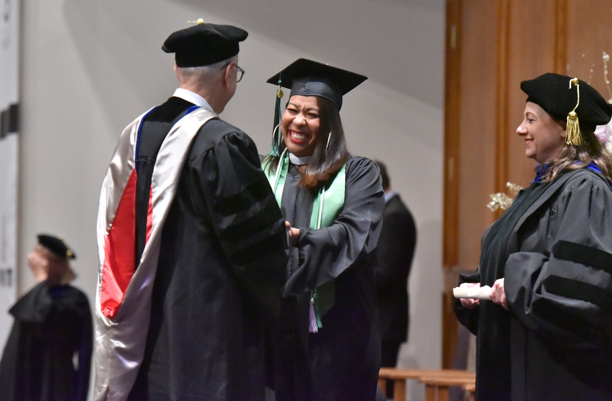 June 8, 2019 Atlanta - Kimberly Cabral (center) reacts as she receives her degree from former President of Argosy University Atlanta Murray Bradfield during 2019 Argosy University Atlanta Commencement at Church of Christ at Bouldercrest in Atlanta on Saturday, June 8, 2019. HYOSUB SHIN / HSHIN@AJC.COM