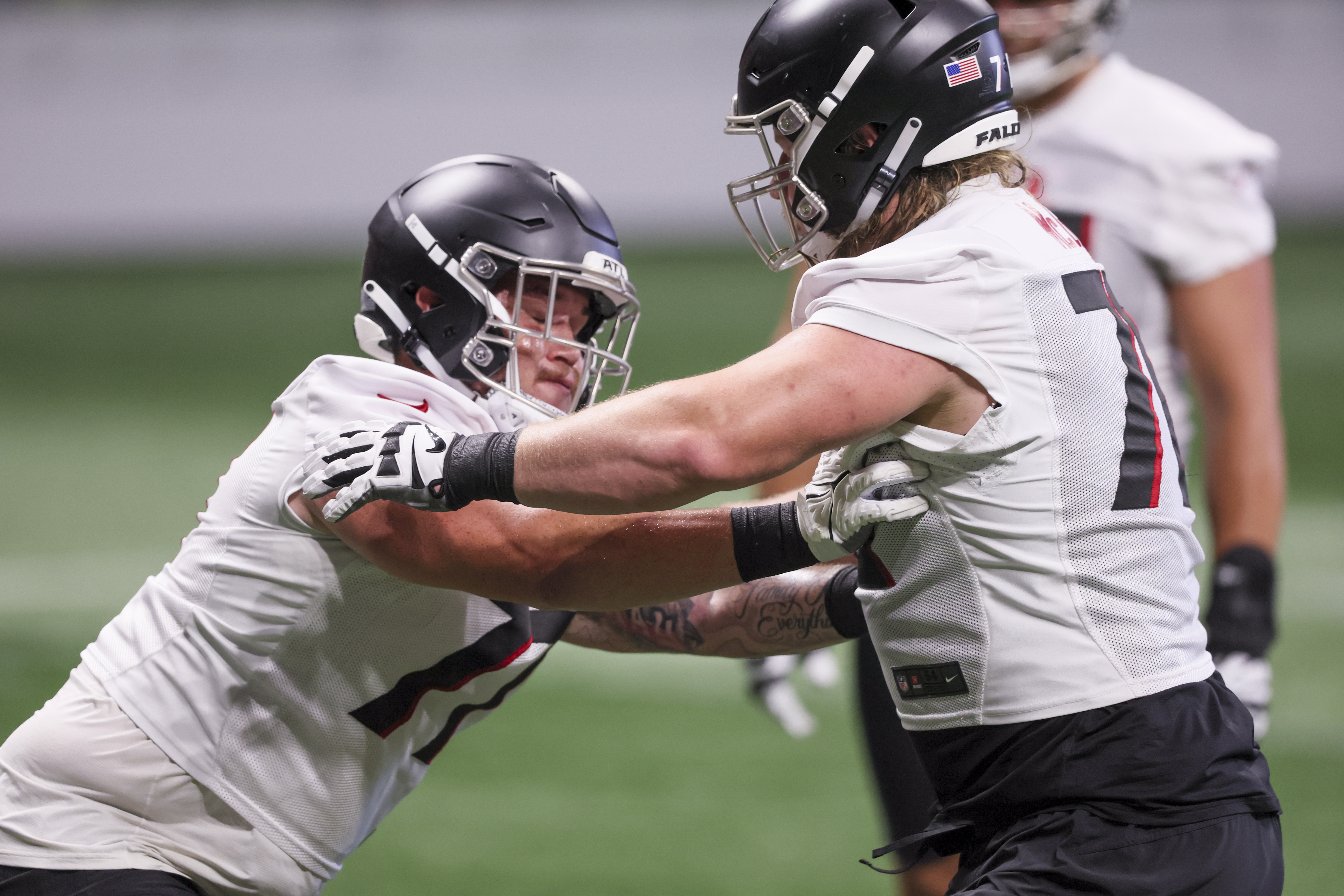 Atlanta Falcons offensive tackle Jalen Mayfield (77) works during