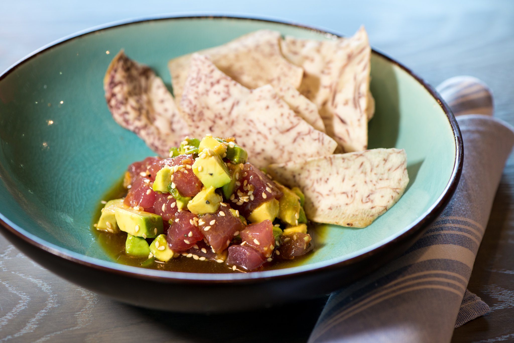 Tuna Poke with avocado, soy-mustard, and taro chips. Photo credit- Mia Yakel.