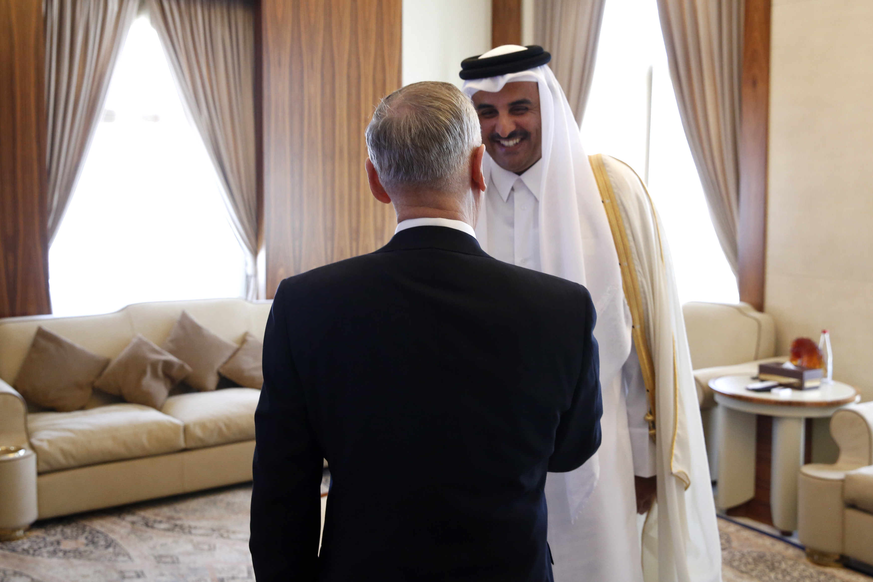 Qatar's Emir Sheikh Tamim Bin Hamad Al-Thani welcomes U.S. Defense Secretary James Mattis (C) at his residence, the Sea Palace on April 22, 2017 in Doha, Qatar.